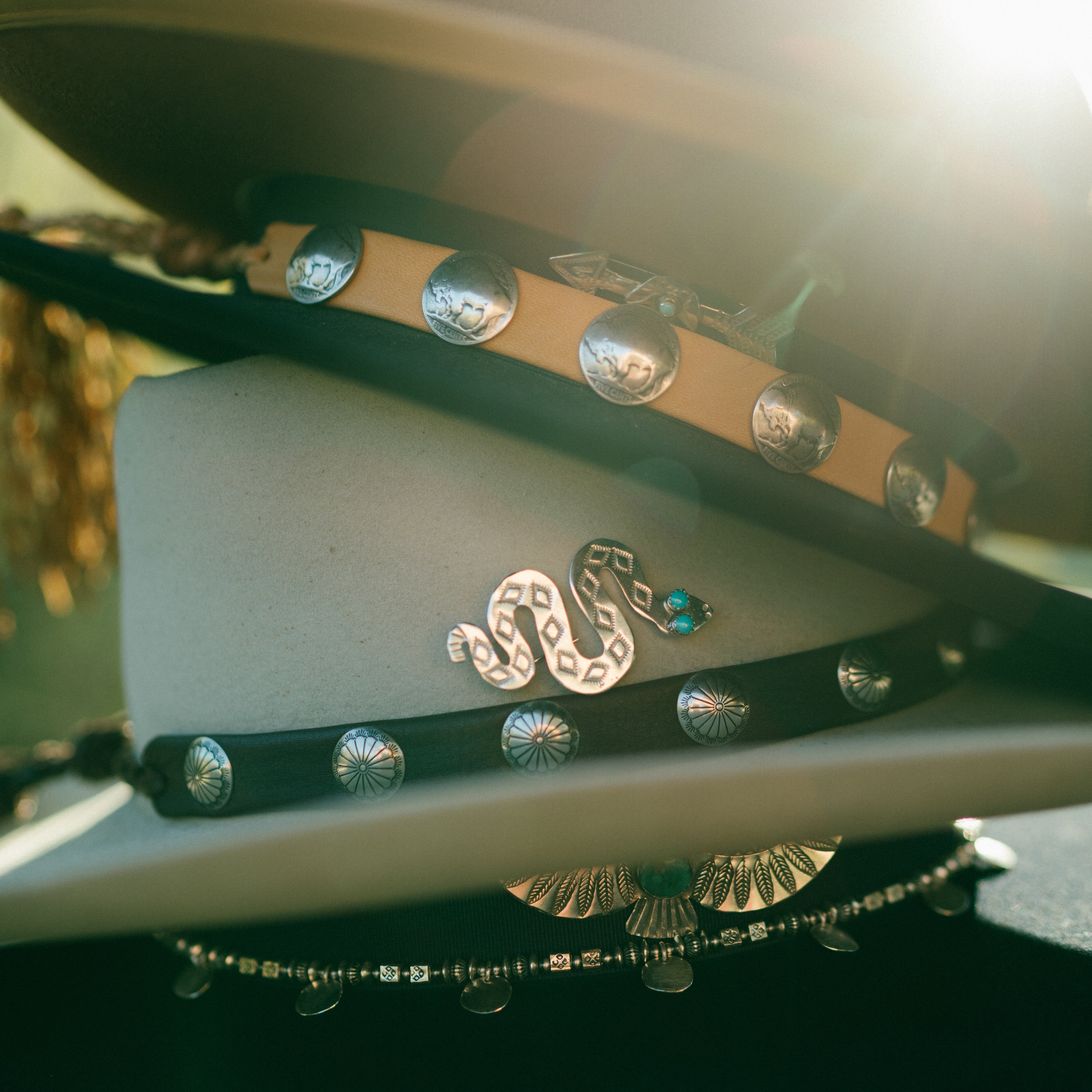 Decorative deerskin leather hatbands and hat pins featuring sterling silver and blue turquoise. Made in USA.
