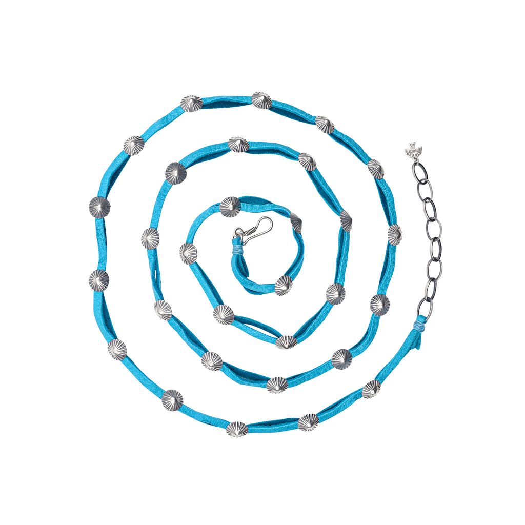 Handcrafted from soft deerskin, this double wrap hatband features classic sterling silver concho buttons. Elevate your style with this unique and versatile accessory.