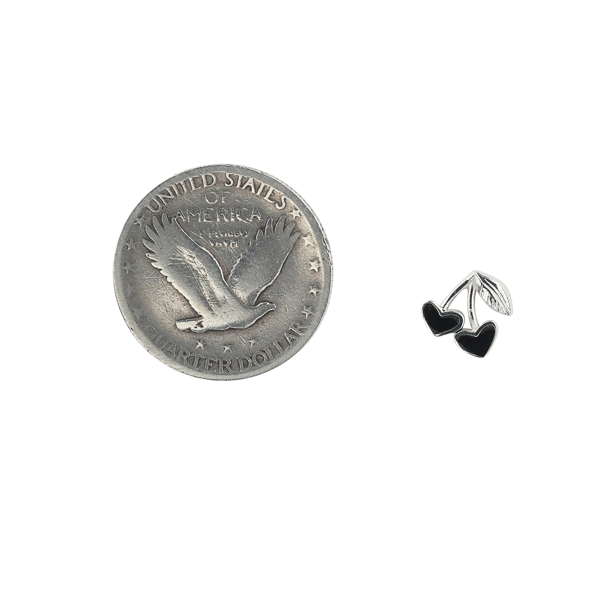 Sterling Silver cherry earrings with black onyx stone inlay next to coin for scale.