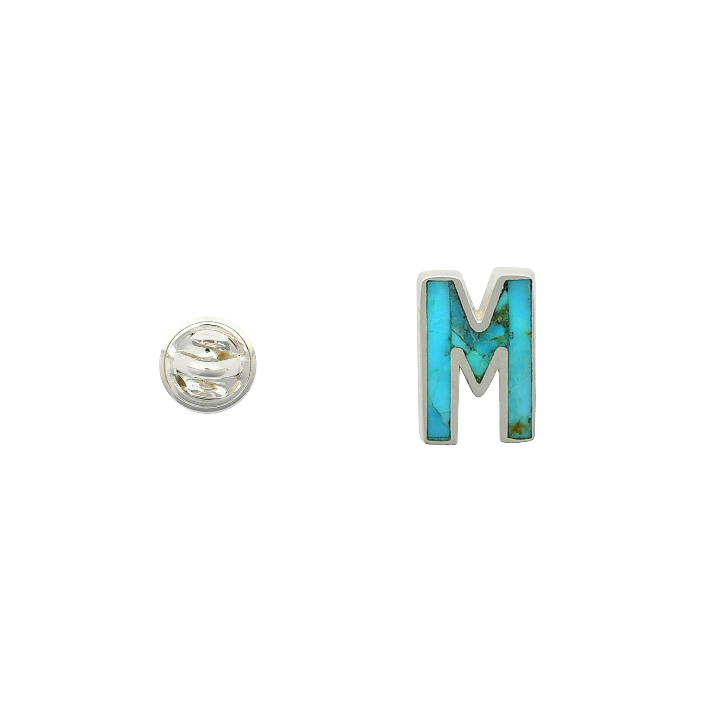 Turquoise letter pin M wrapped in sterling silver next to silver tack back.