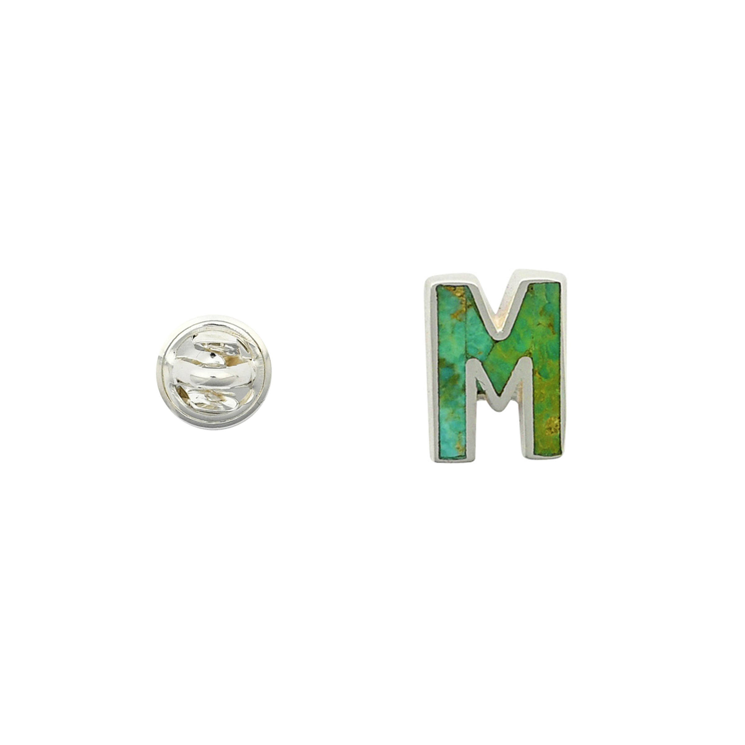 Green Turquoise letter pin M wrapped in sterling silver next to silver tack back.
