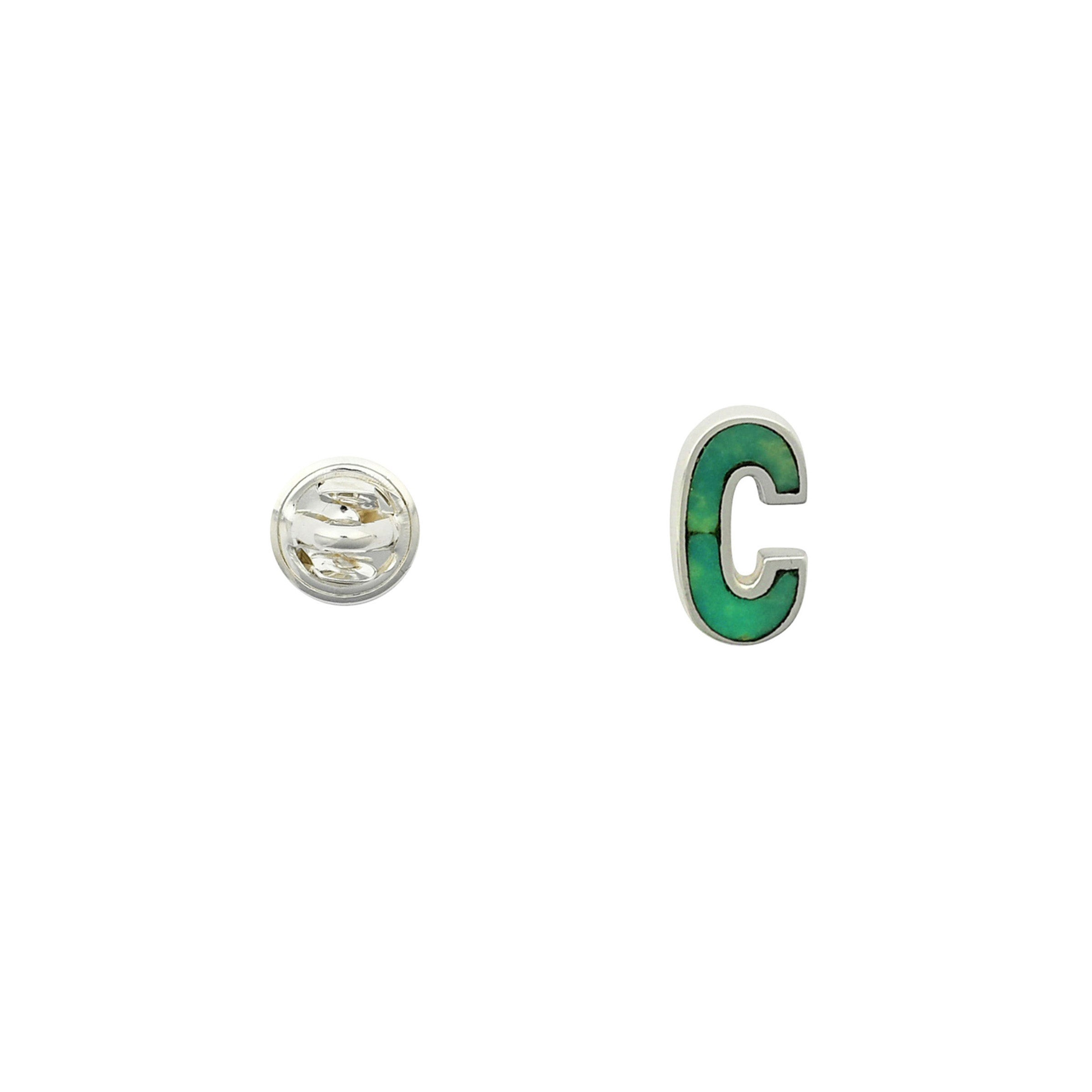 Green Turquoise letter pin C wrapped in sterling silver next to silver tack back.