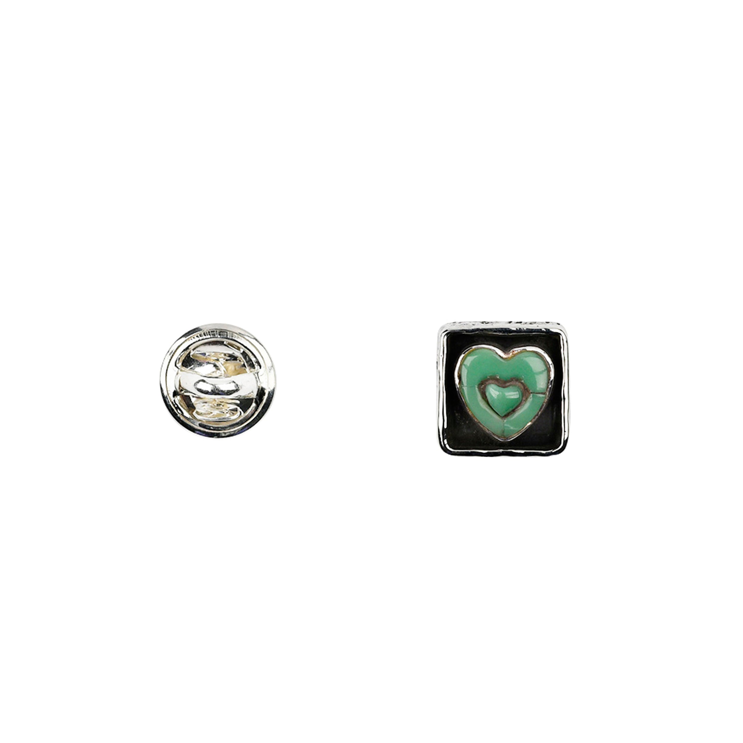 Sterling silver pin back and front with turquoise heart motif set in sterling silver square with oxidized sides around sunken heart.