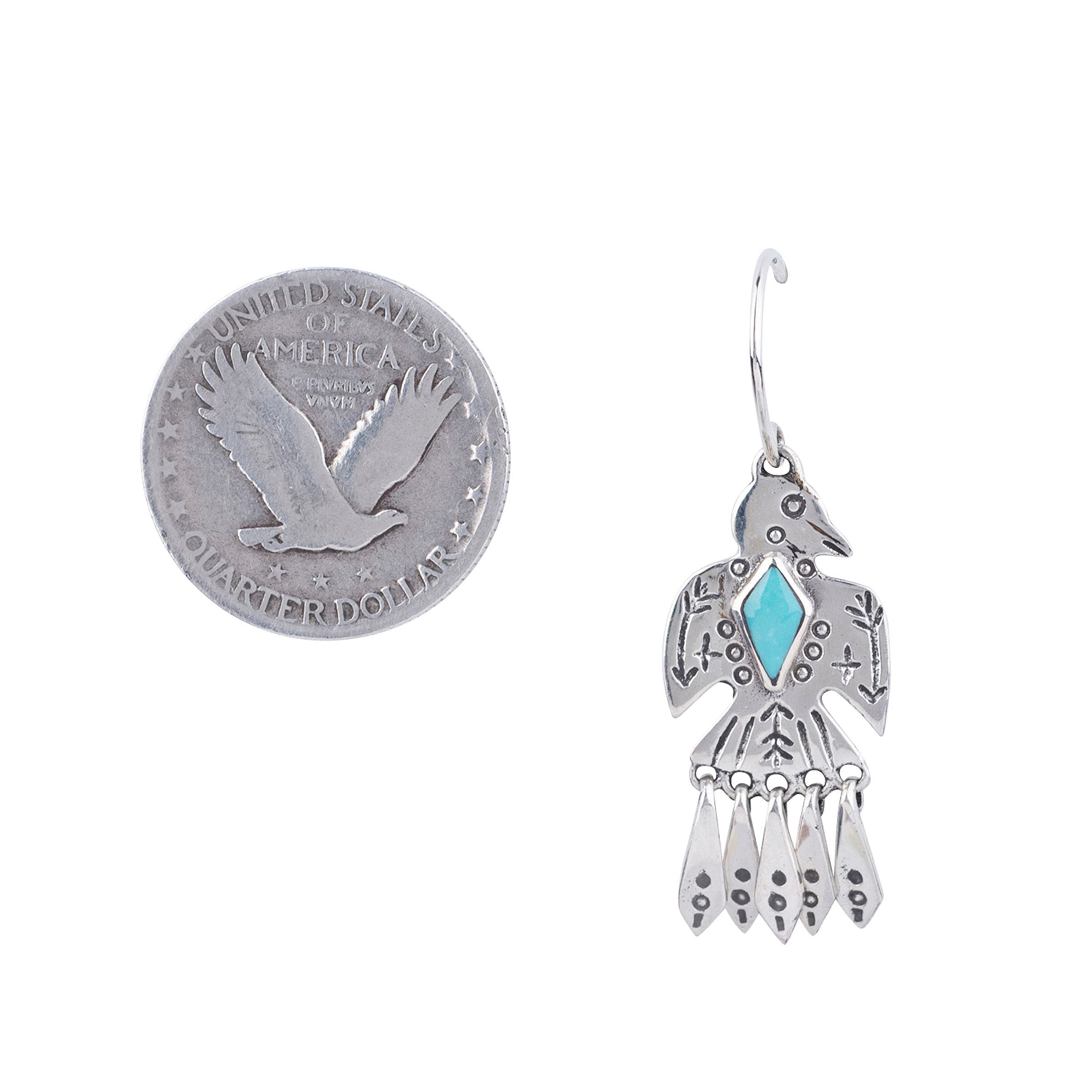 A pair of sterling silver and turquoise earrings in the shape of a bird.
