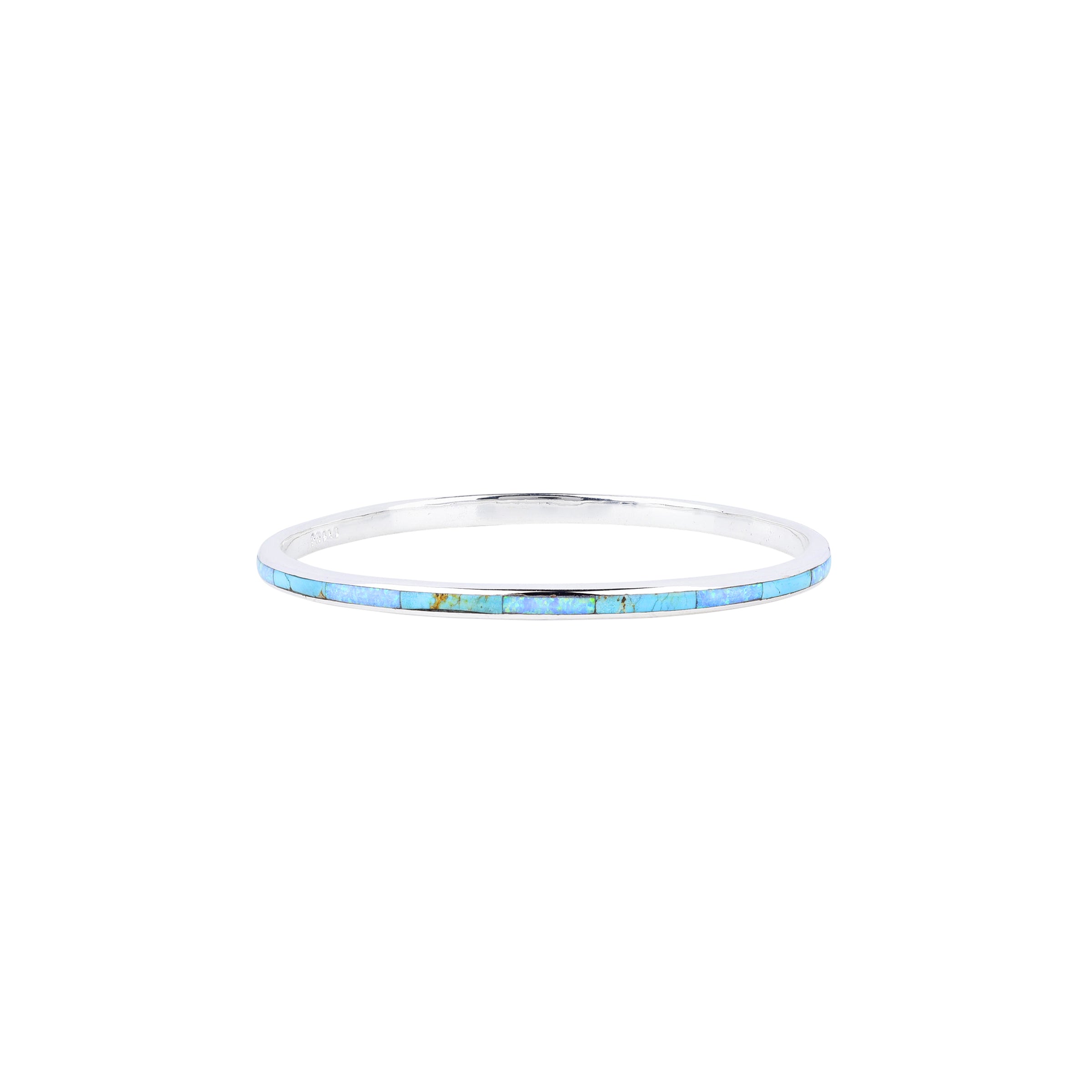 A sterling silver Infinity bangle with blue turquoise inlay stones from our Bird and Arrow collection.