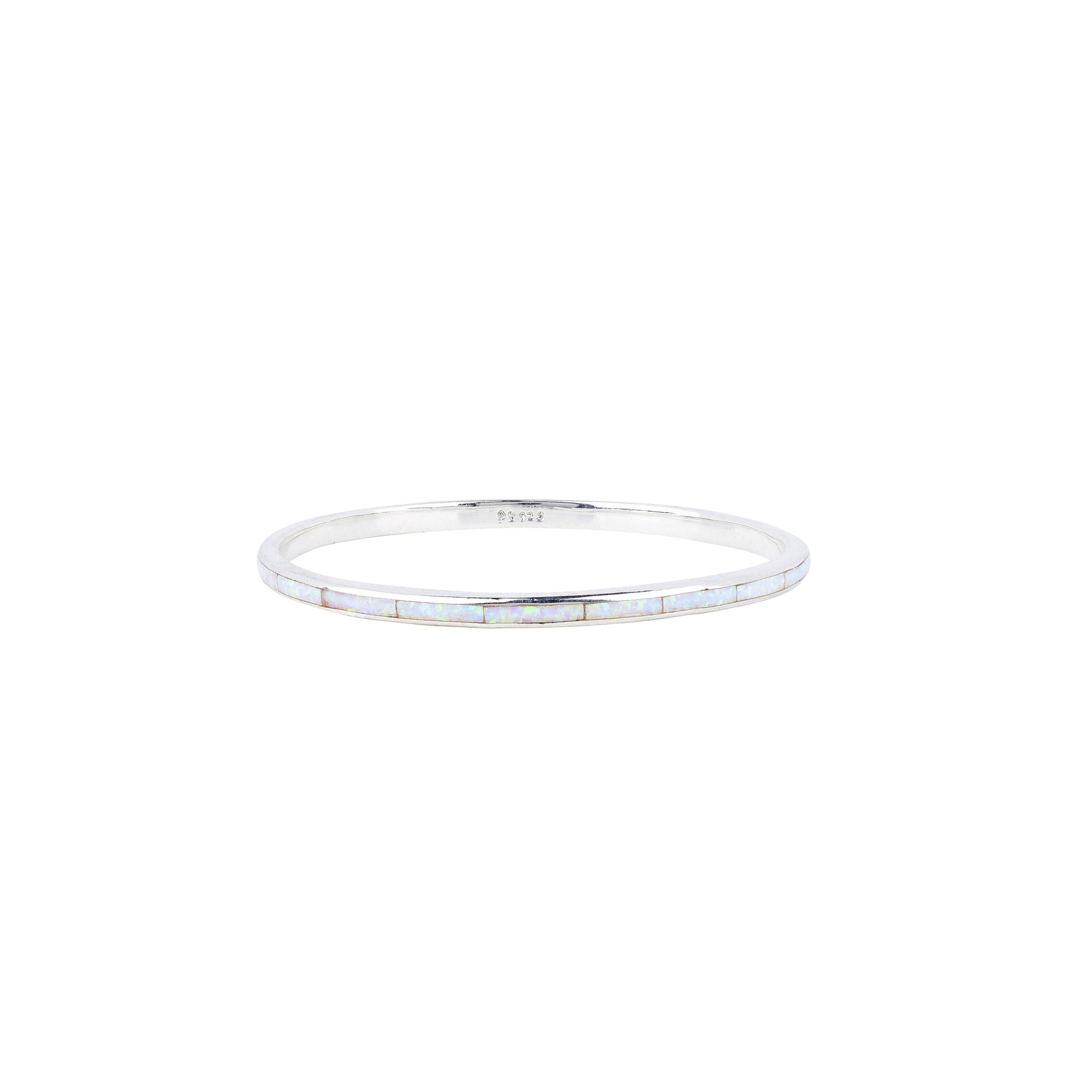 A sterling silver Infinity bangle with white opal inlay stones from our Bird and Arrow collection.