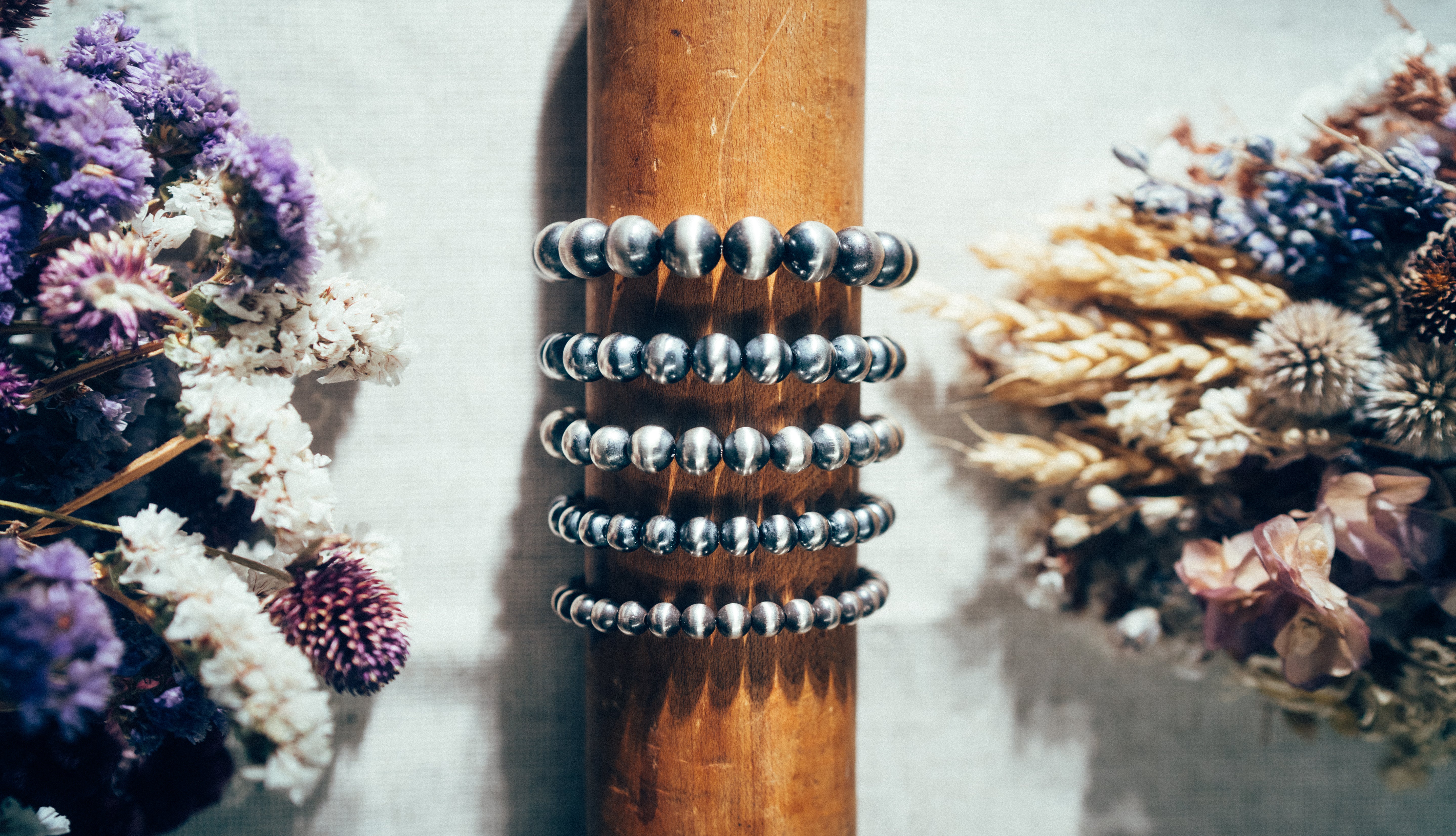 A stretch bracelet featuring round sterling silver beads representing the 'Desert Pearl' style.