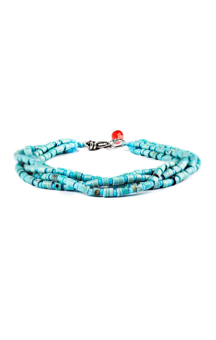 Multi-strand Turquoise bracelet with sterling silver clasp and one coral faceted bead side view