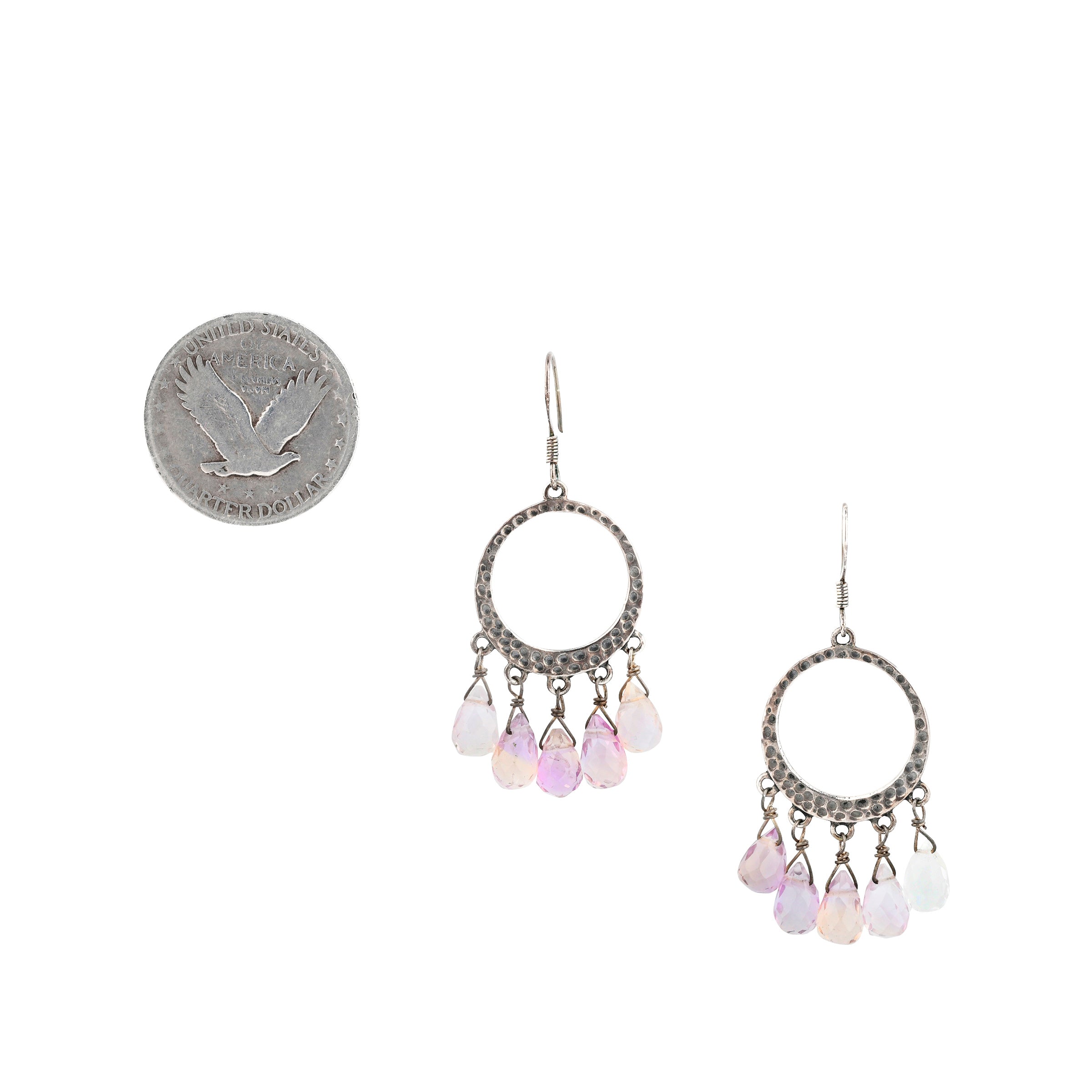 Sterling silver hoops with purple and white looking dangle beads below with coin for scale.