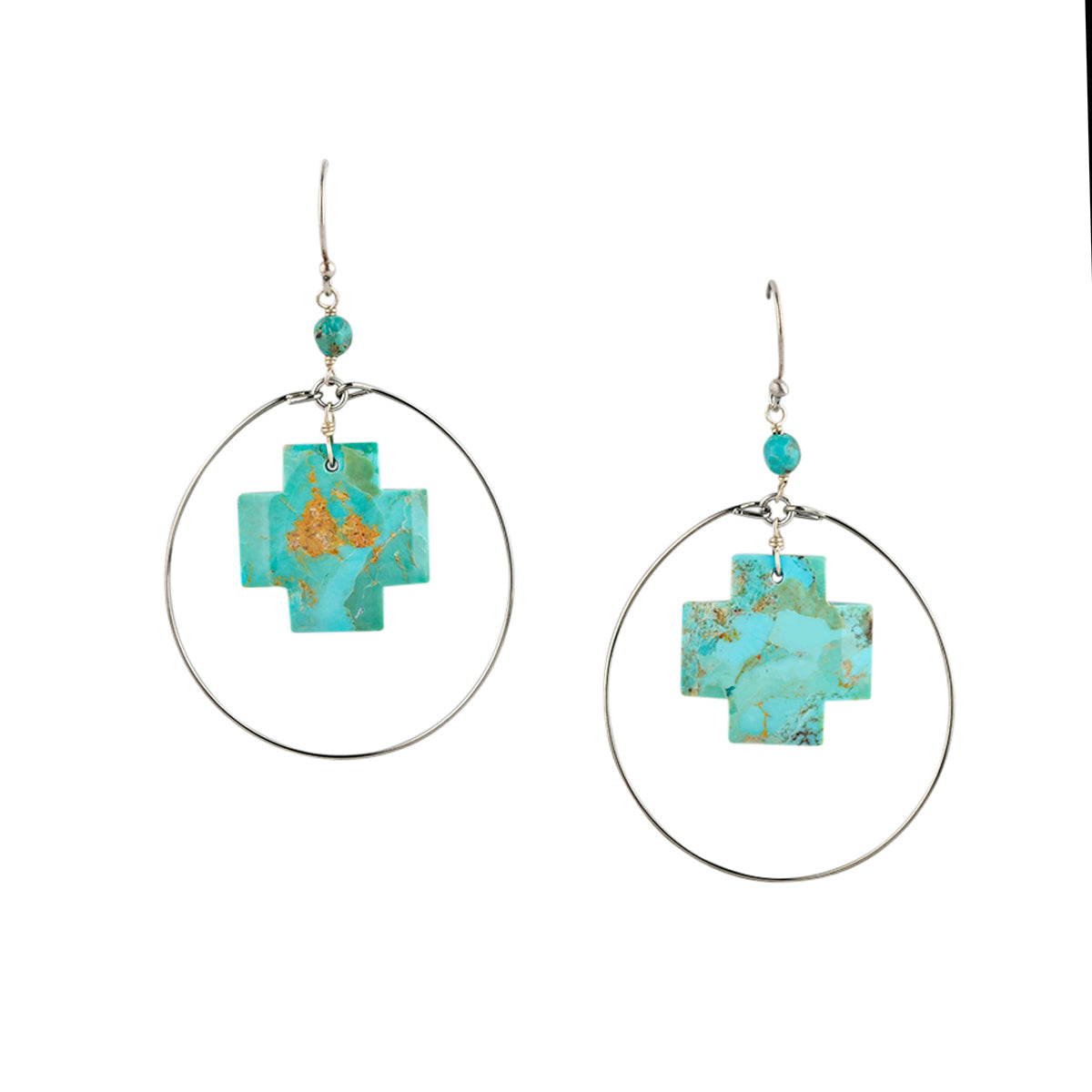 Turquoise cross earrings with silver hoop surround.
