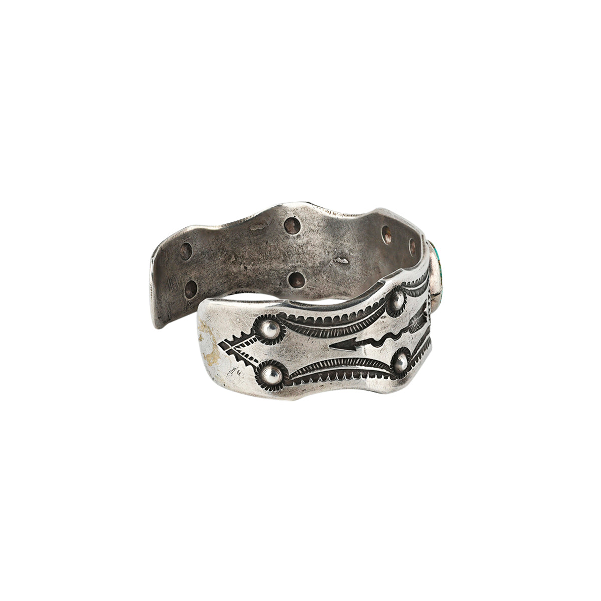 Silver cuff featuring blue turquoise in the middle of the cuff surrounded by southwestern design and arrows