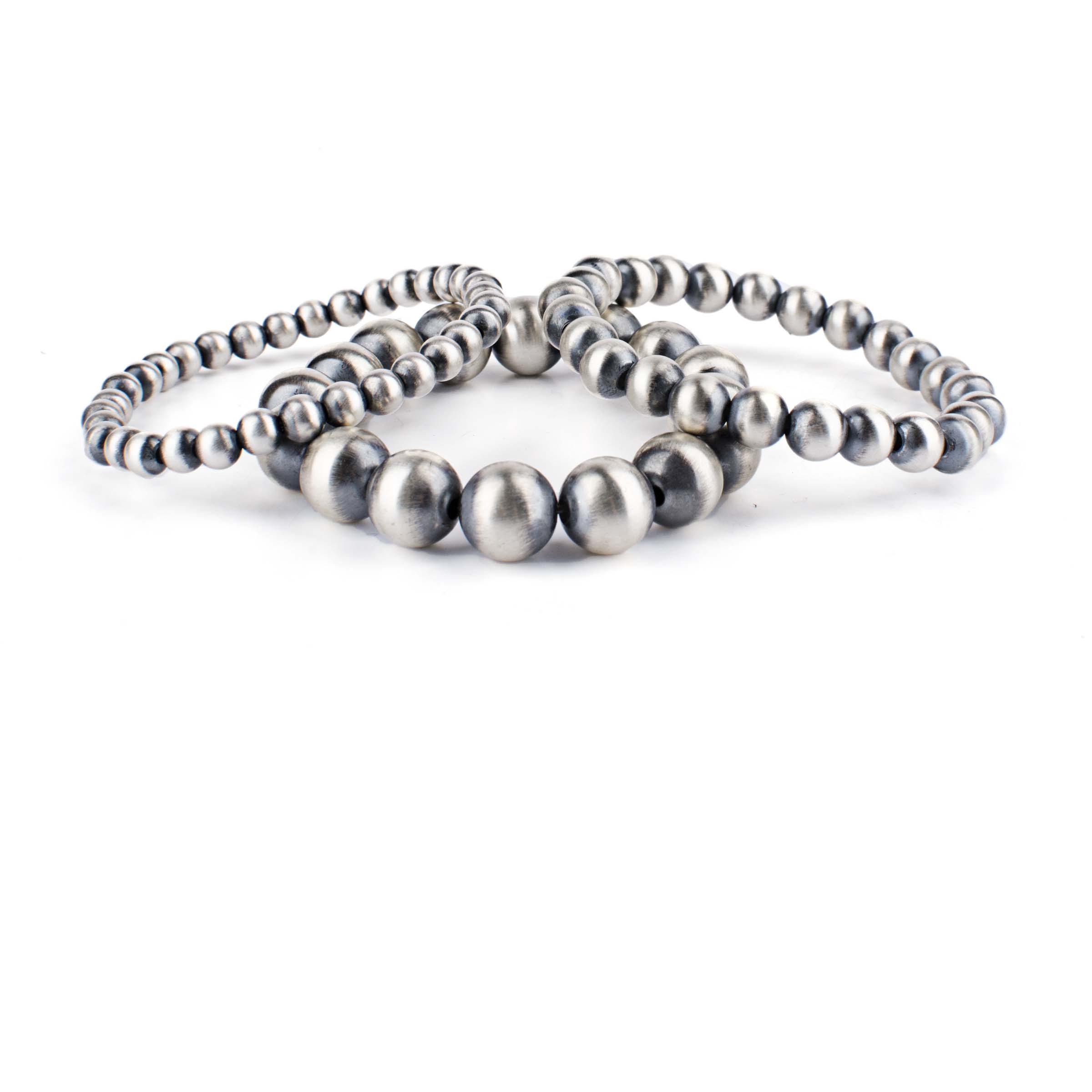 A stretch bracelet featuring round sterling silver beads representing the 'Desert Pearl' style.