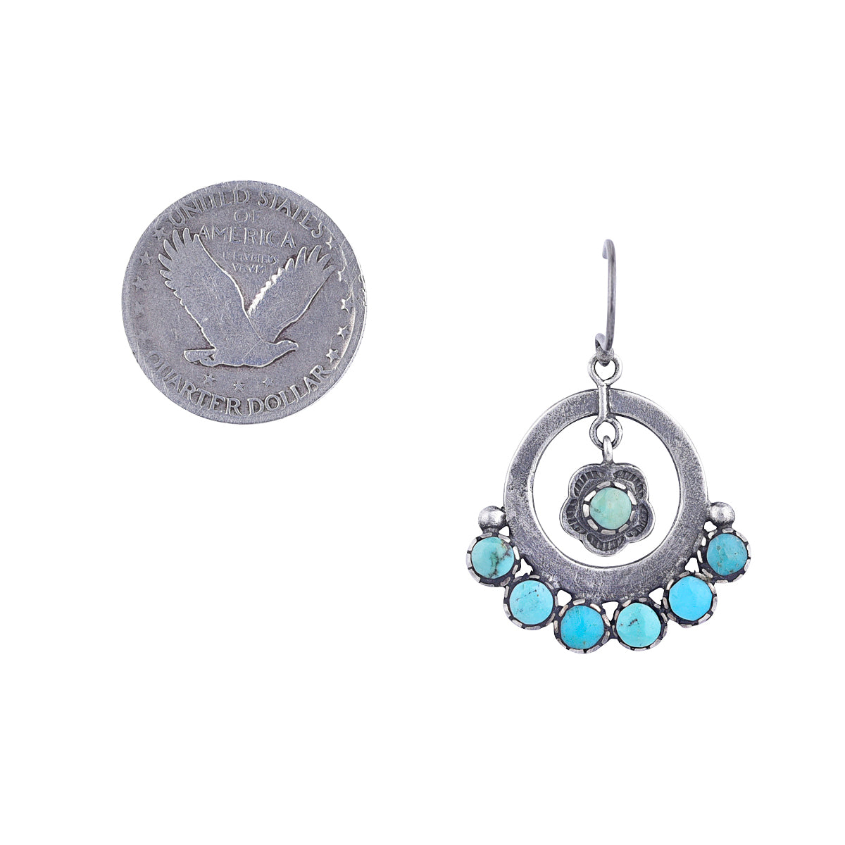 sterling silver and turquoise earring with flower drop motif next to coin for scale