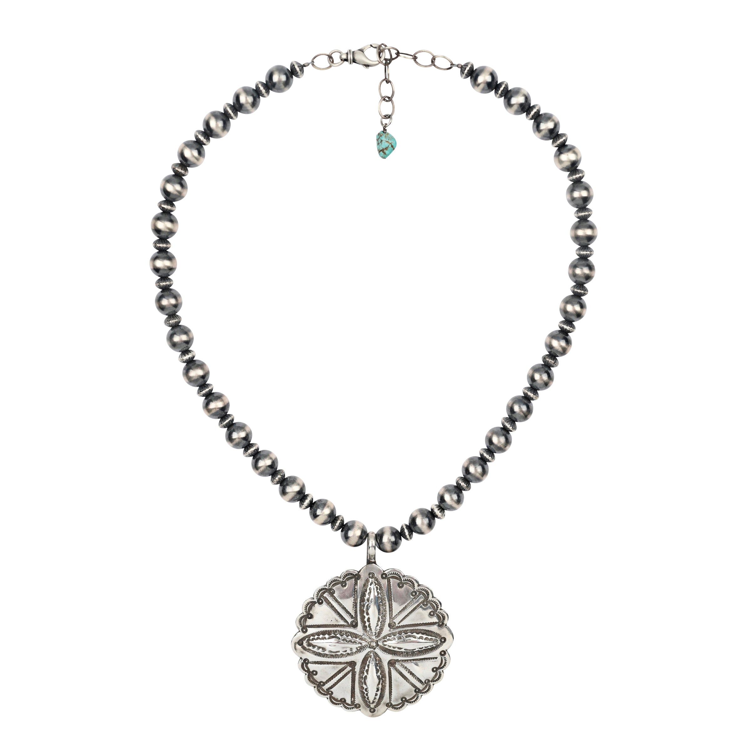 The Tierra Necklace features a large concho-style pendant with Southwestern motif stamping strung on a strand of Desert Pearls. Pendant made by Buffalo. This piece was showcased in the Sundance Catalog.