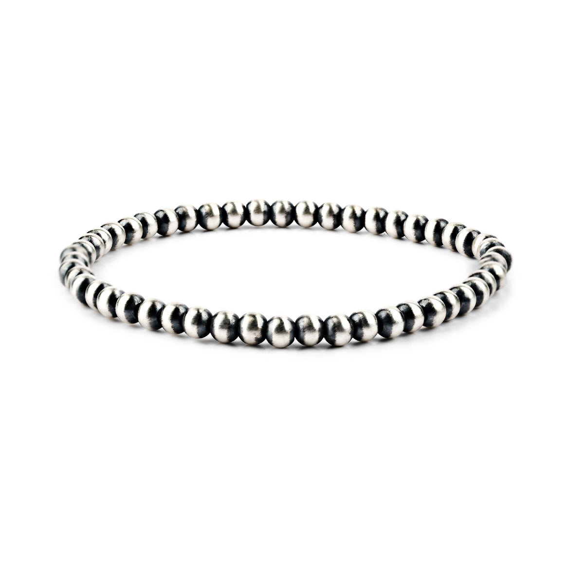 A stretch bracelet featuring round sterling silver beads representing the 'Desert Pearl' style.
