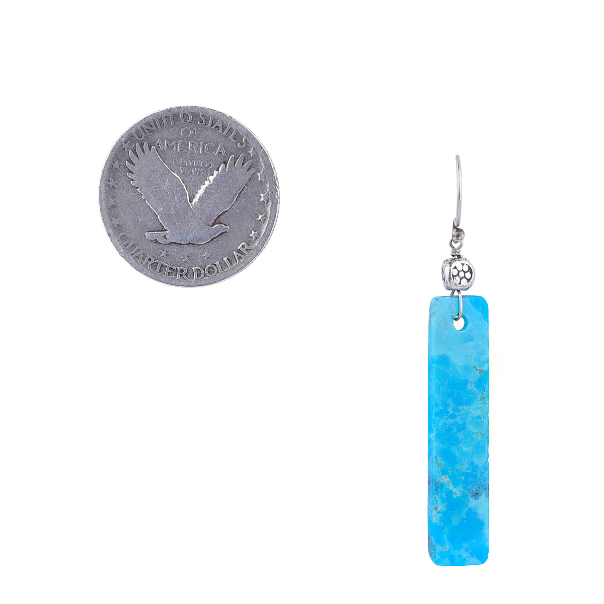 Turquoise drop earring with Thai silver bead top next to coin for scale.