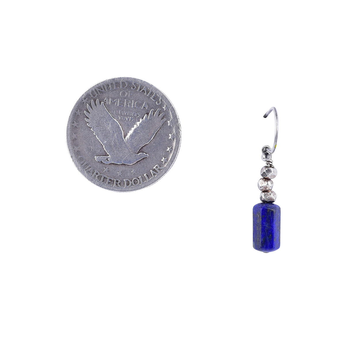 Thai silver beads stacked on top of lapis for these drop earring next to coin for scale
