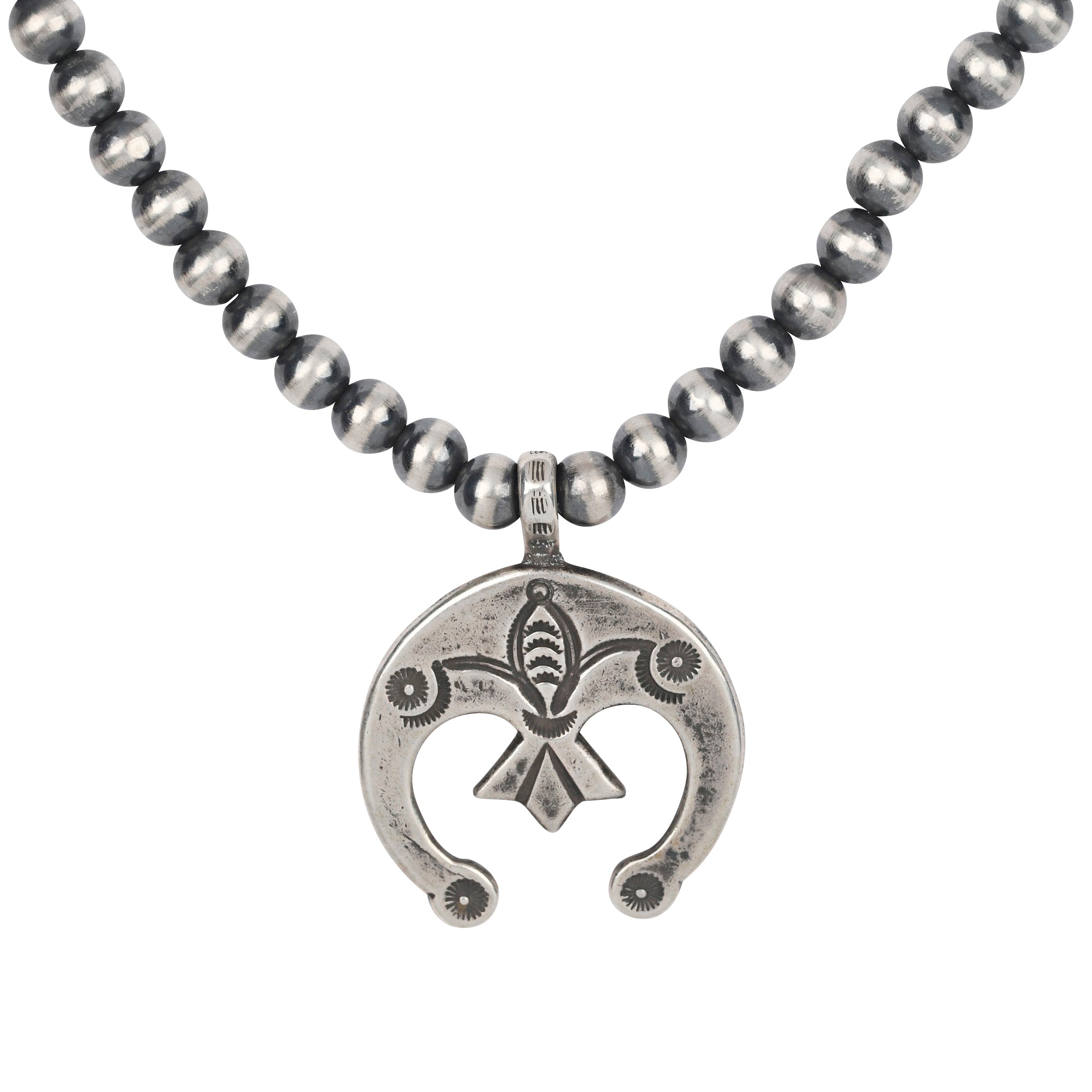 A Sterling Silver stamped Naja Pendant strung on a string of Desert Pearls. Features Santa Fe Style motifs and is long enough to be layered with your other favorite pieces.