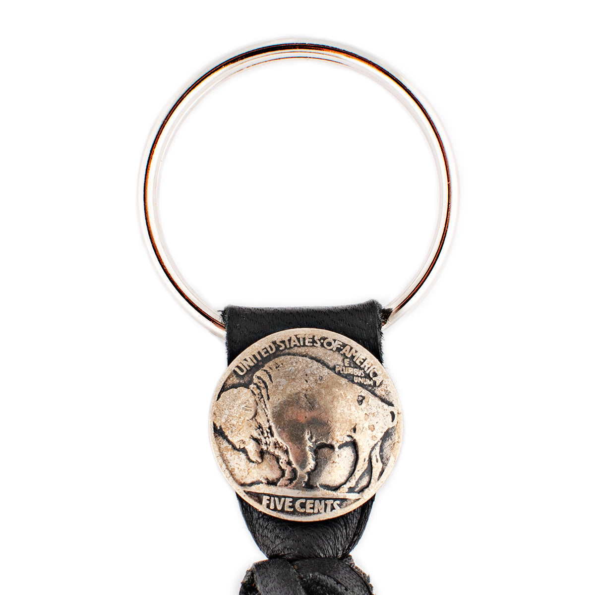 A black leather tassel keychain with a silver metal key ring and a vintage buffalo nickel.