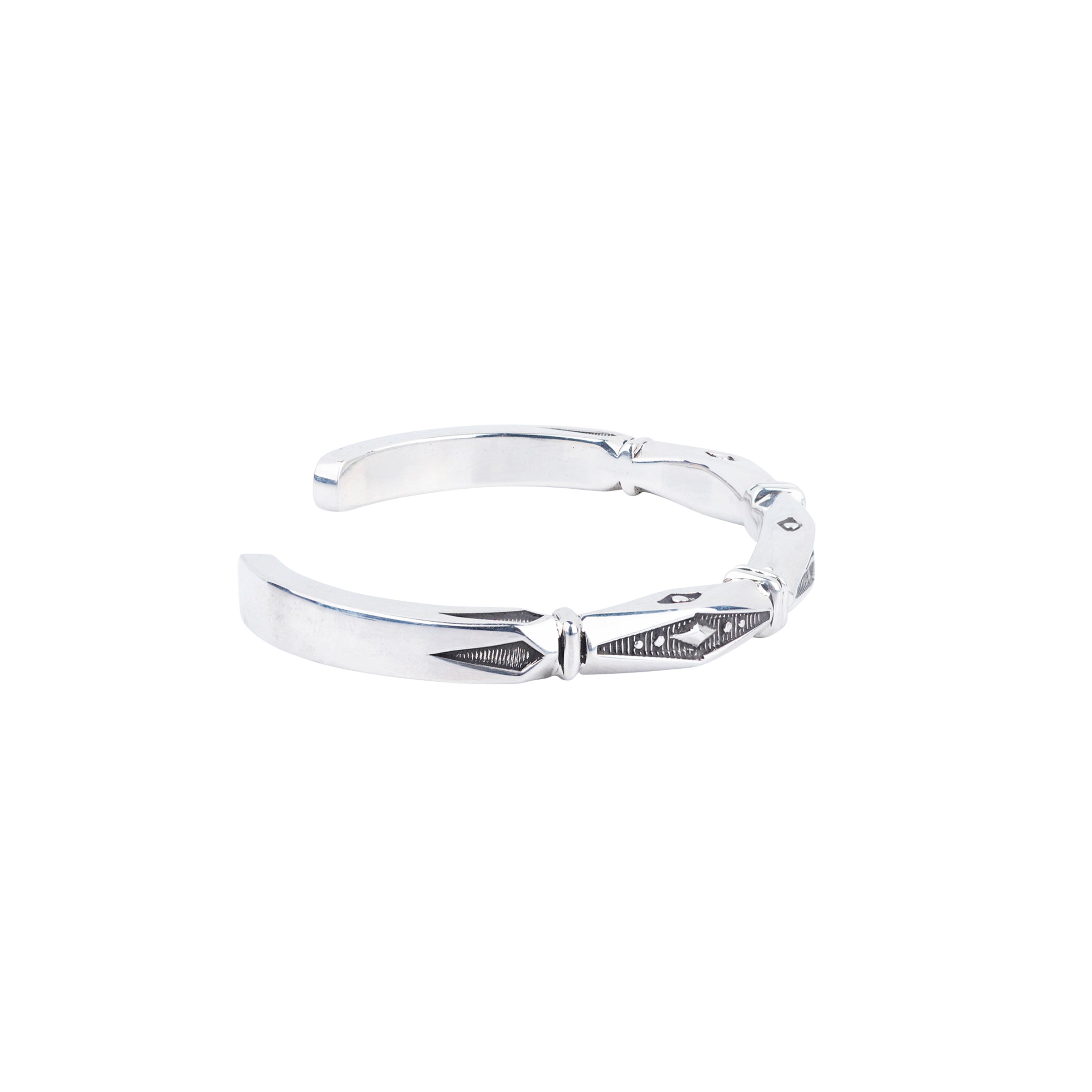 Silver bracelet stamped with textured diamond shapes and square banding.