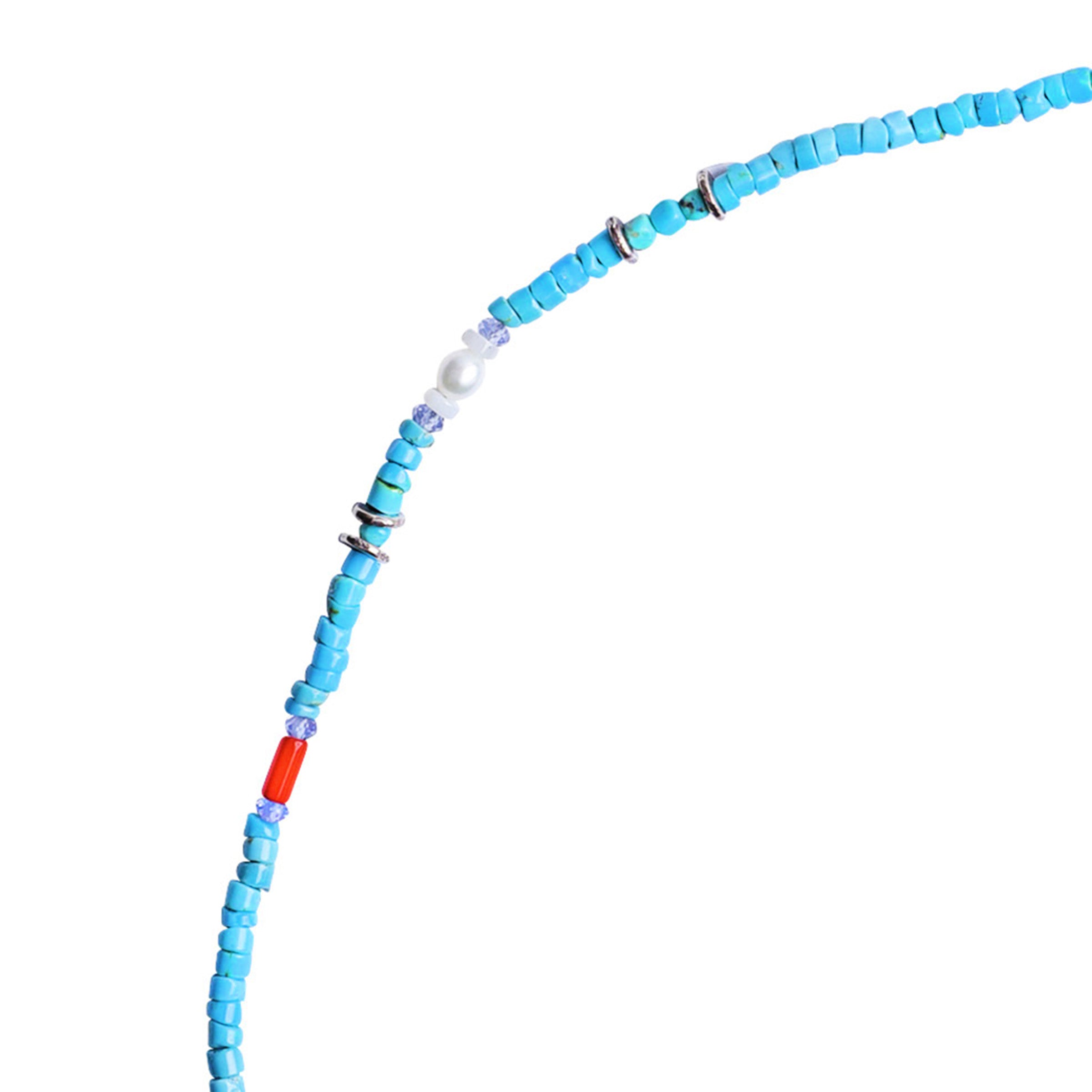 A Peyote Bird Original necklace featuring sterling silver, blue turquoise, mother of pearl, fresh water pearl, red coral, and quartz. Made in USA.