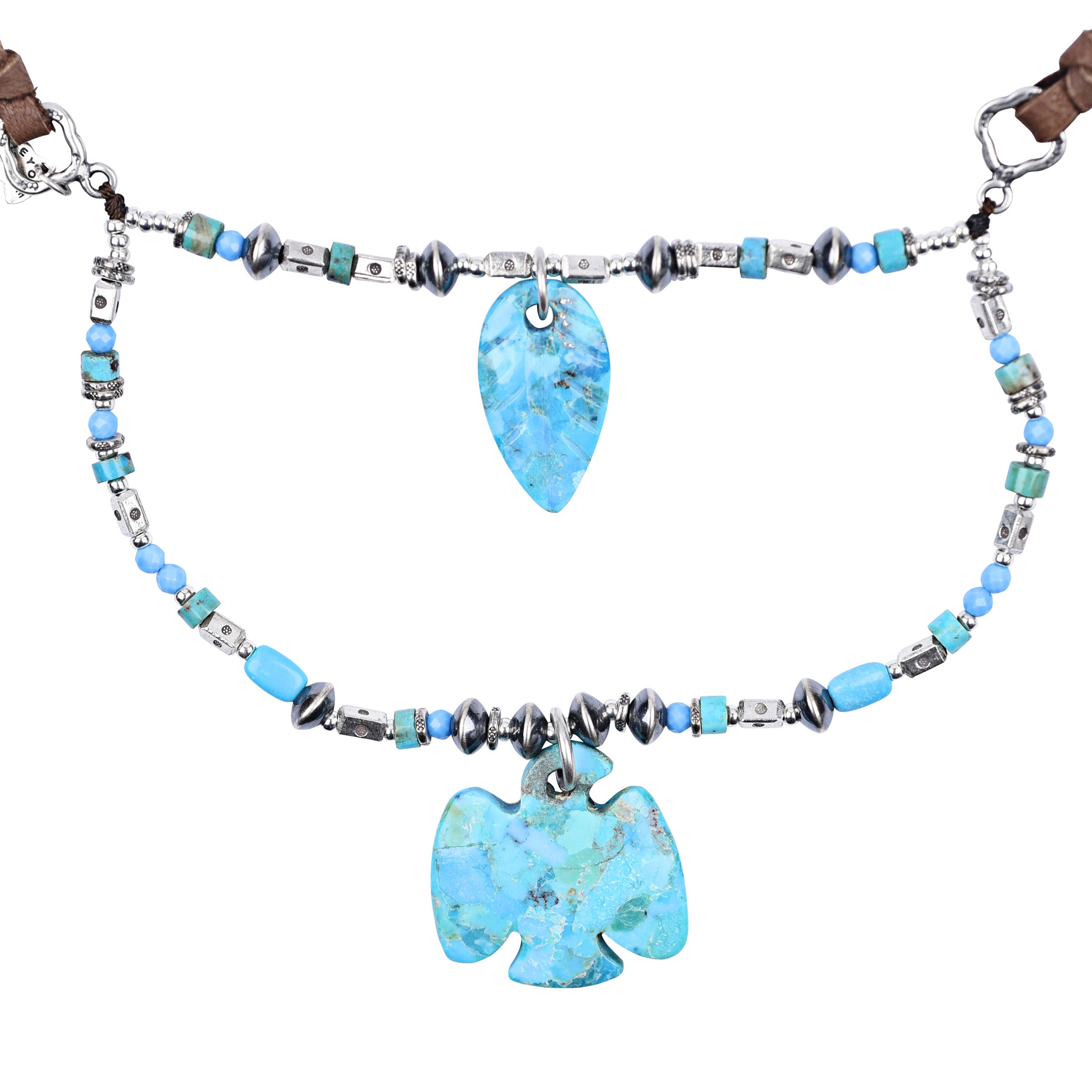 A boho multi-layered leather and sterling silver necklace featuring turquoise, thunderbird carving, and leaf carving