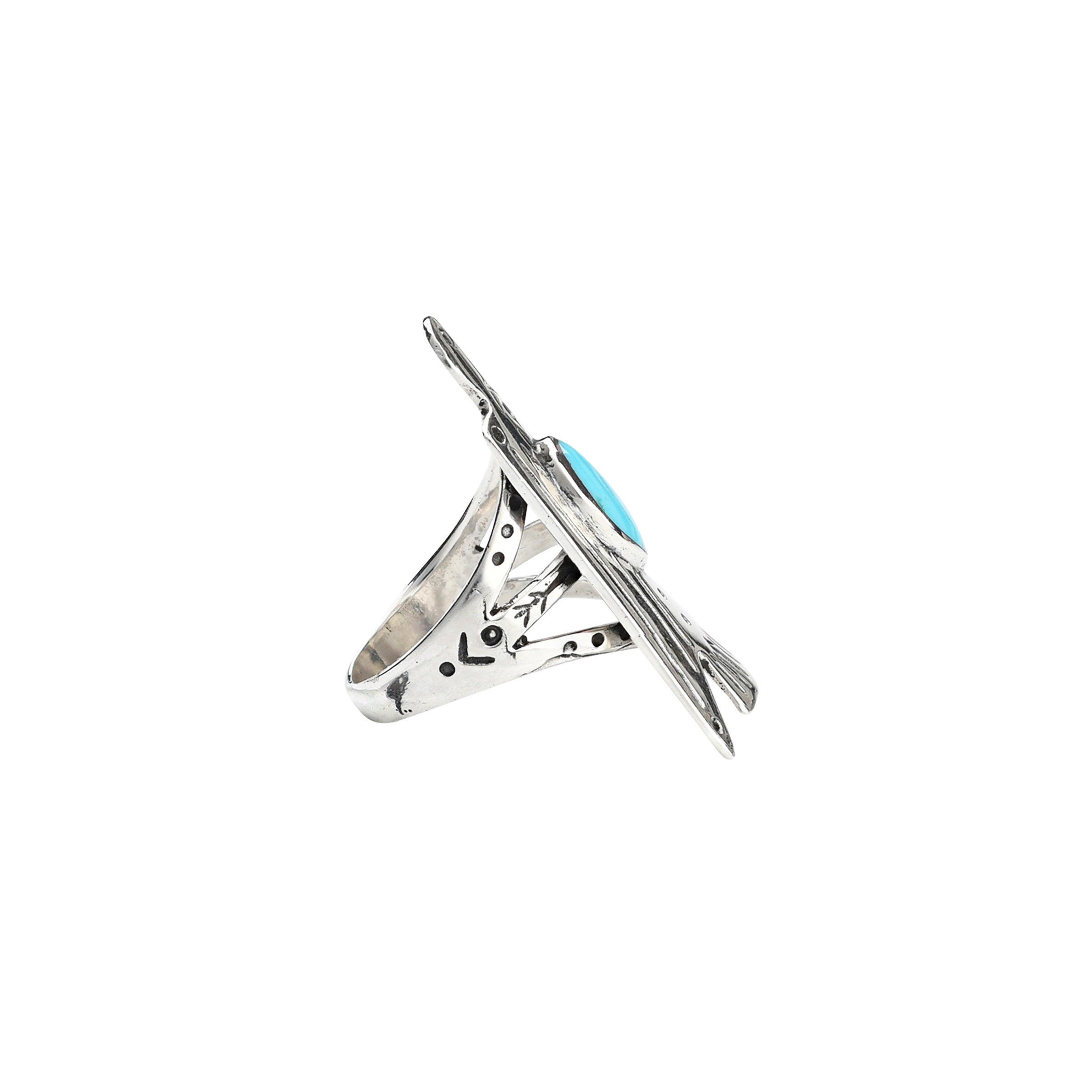 A shield ring of a large eagle with Blue Turquoise as the centerpiece with stamped detailing