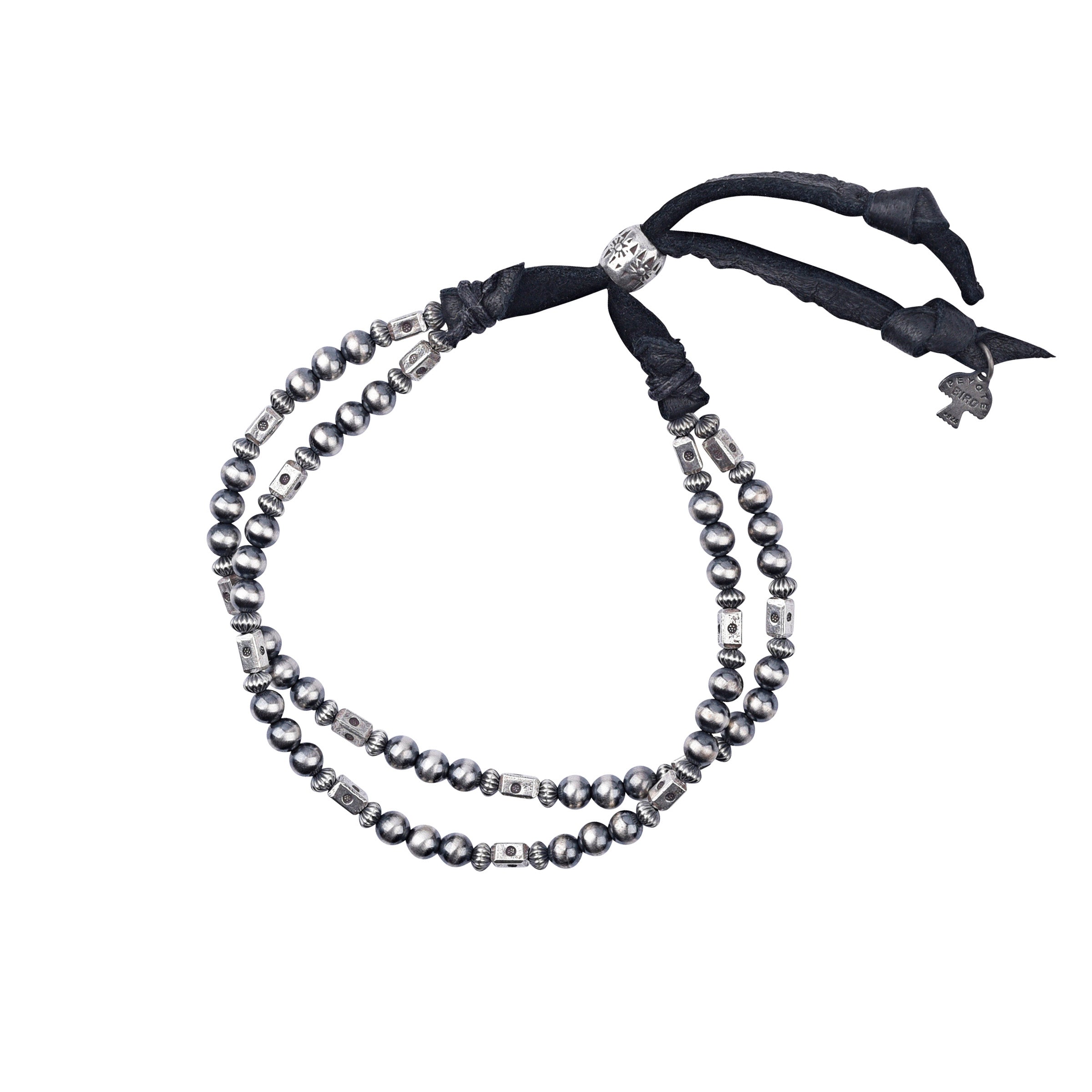 An adjustable bracelet featuring deerskin leather, desert pearls, sterling silver accents and beading