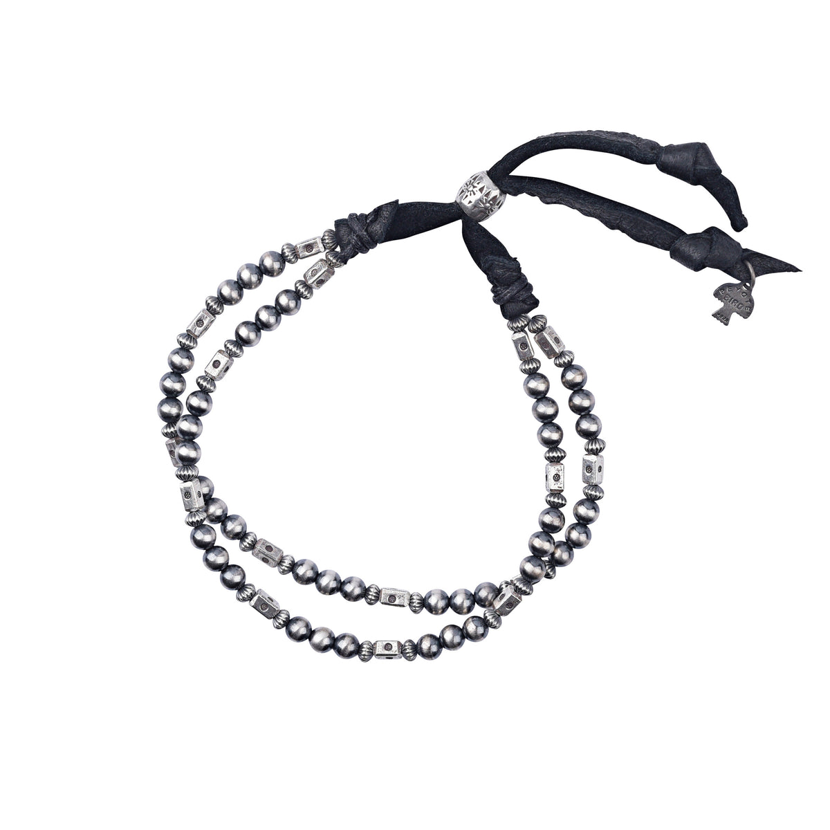 An adjustable bracelet featuring deerskin leather, desert pearls, sterling silver accents and beading