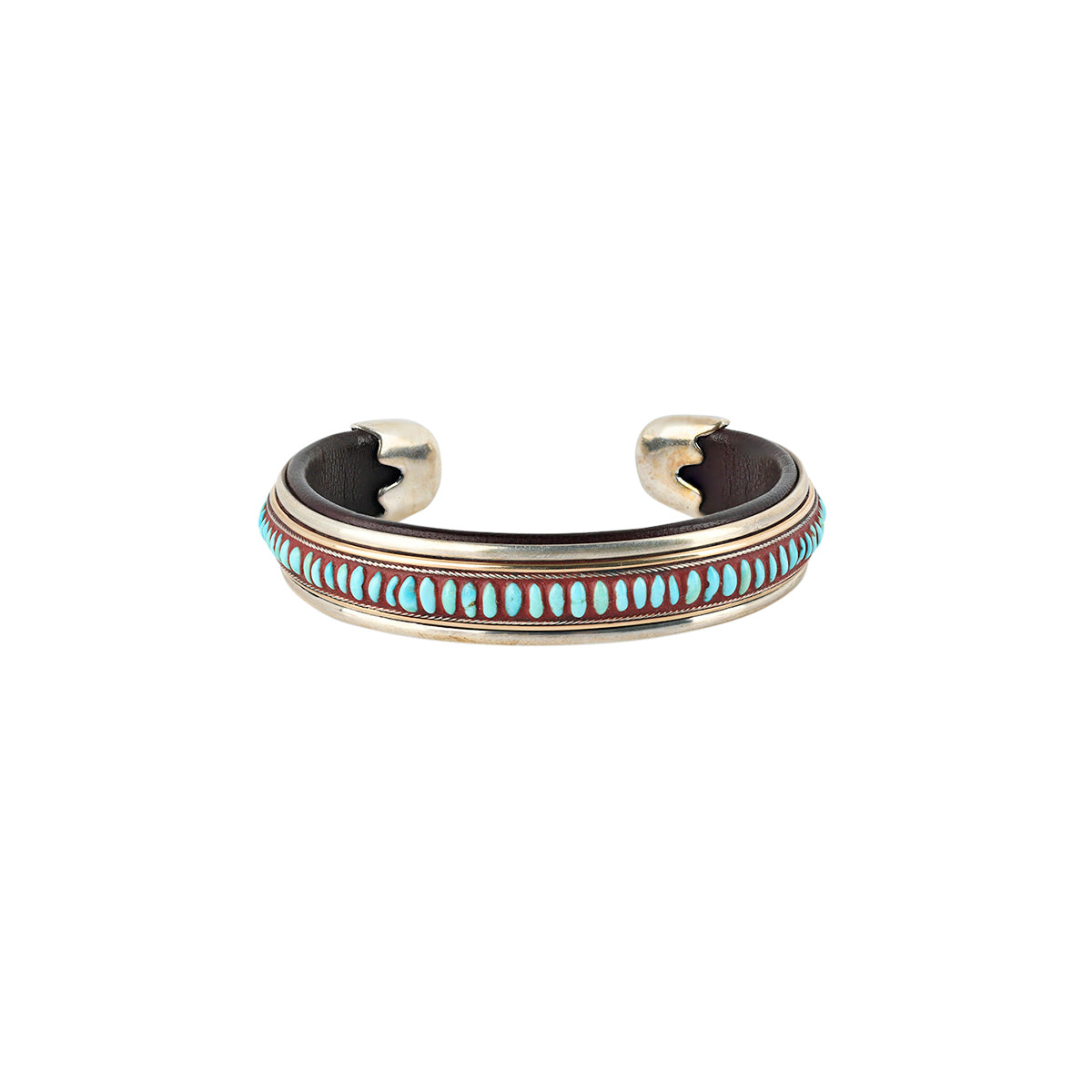 An artisanal cuff bracelet featuring blue turquoise, sterling silver, and leather