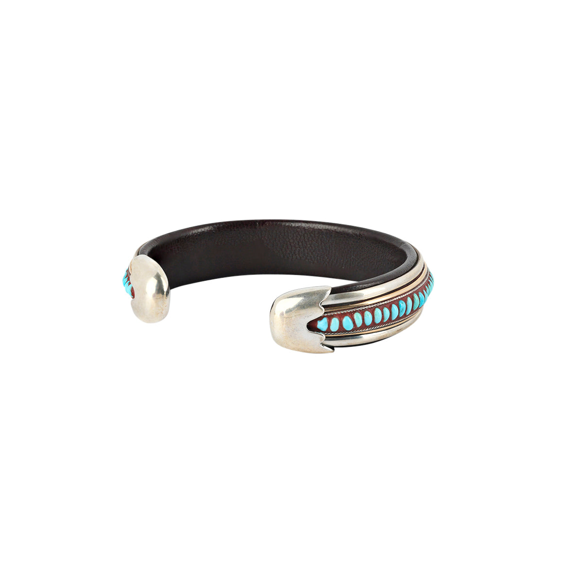 An artisanal cuff bracelet featuring blue turquoise, sterling silver, and leather