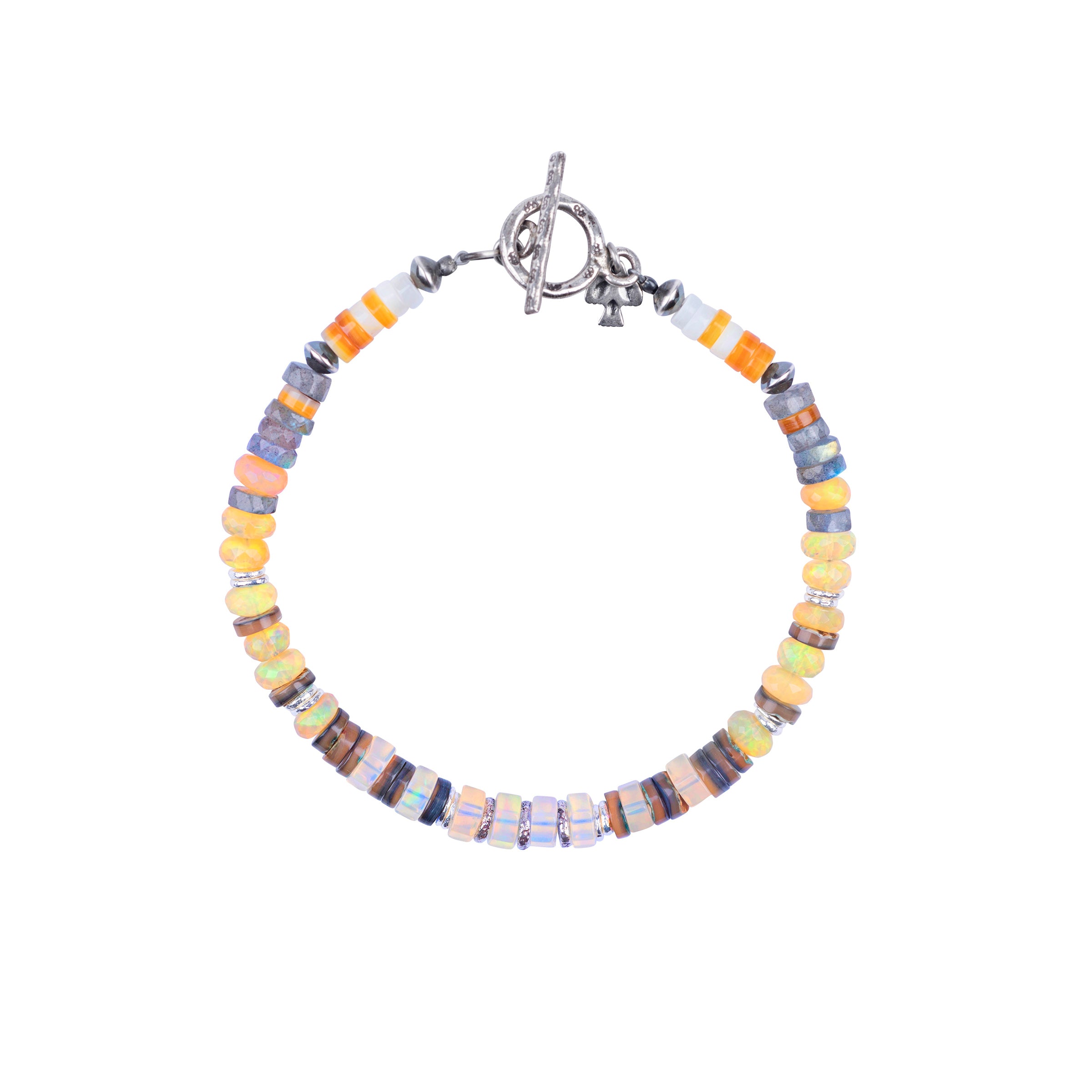 A Peyote Bird Original beaded bracelet strung with White Mother of Pearl, Yellow Mother of Pearl, Ethiopian Opals, Labradorite, and Abalone. This piece includes Desert Pearl Saucers and Thai Sterling Silver beading accents. Finished with a Sterling Silver bar and hoop toggle.