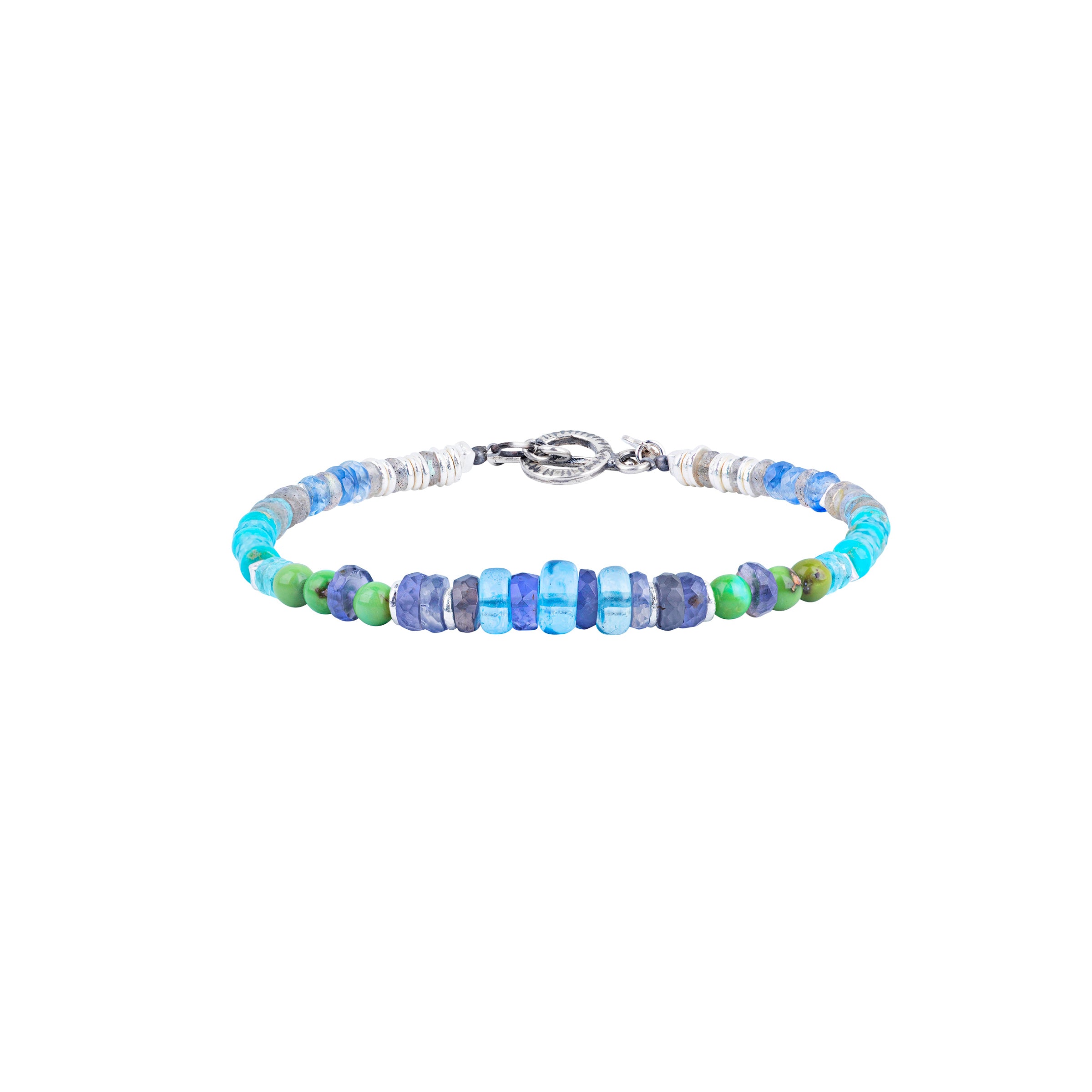 A Peyote Bird Original beaded bracelet strung with Labradorite, Iolite, Blue Turquoise, Green Turquoise, Kyanite, Blue Crystal, and Apatite. Finished with a Sterling Silver toggle clasp for a stylish fit