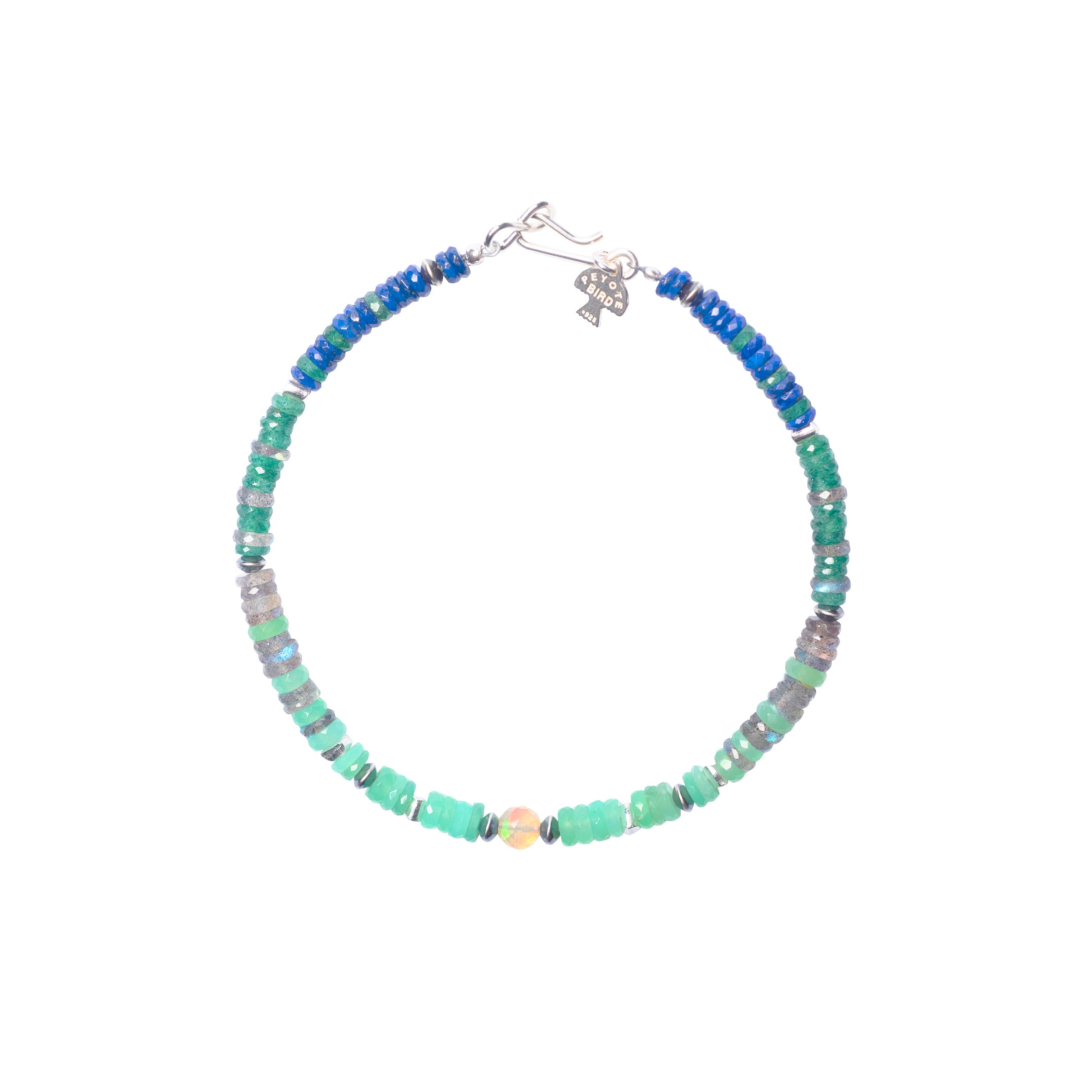 The Bristol Bracelet is a Peyote Bird Original beaded bracelet strung with Lapis, Labradorite, Chrysoprase, Emerald, Desert Pearls, and an Ethiopian Opal as the centerpiece. Finished with a Sterling Silver hook toggle for a secure and stylish fit.