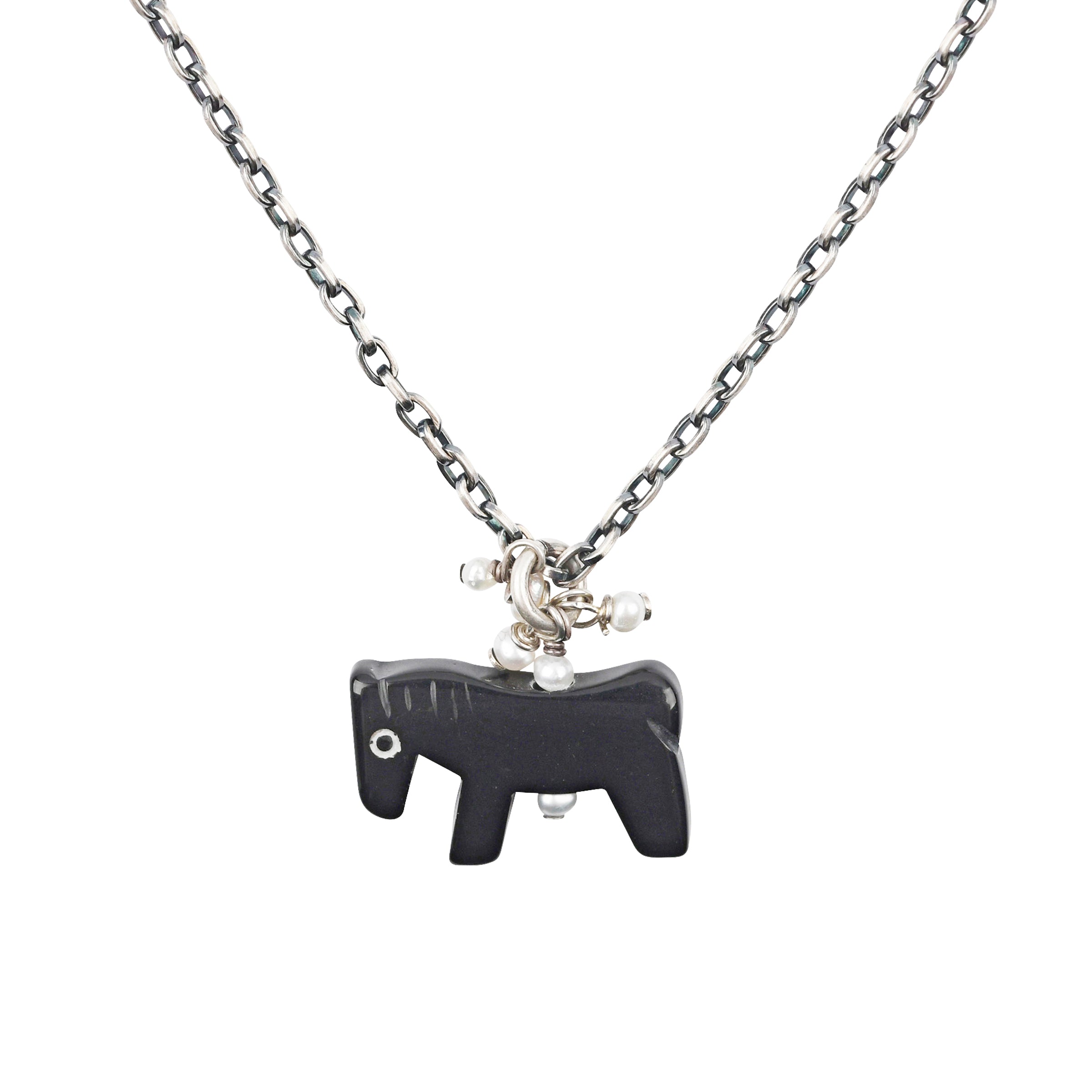 A Sundance staple piece - a sweet little horse hand-carved from Onyx topped with Freshwater Pearl dangle charms on a sterling silver link chain.