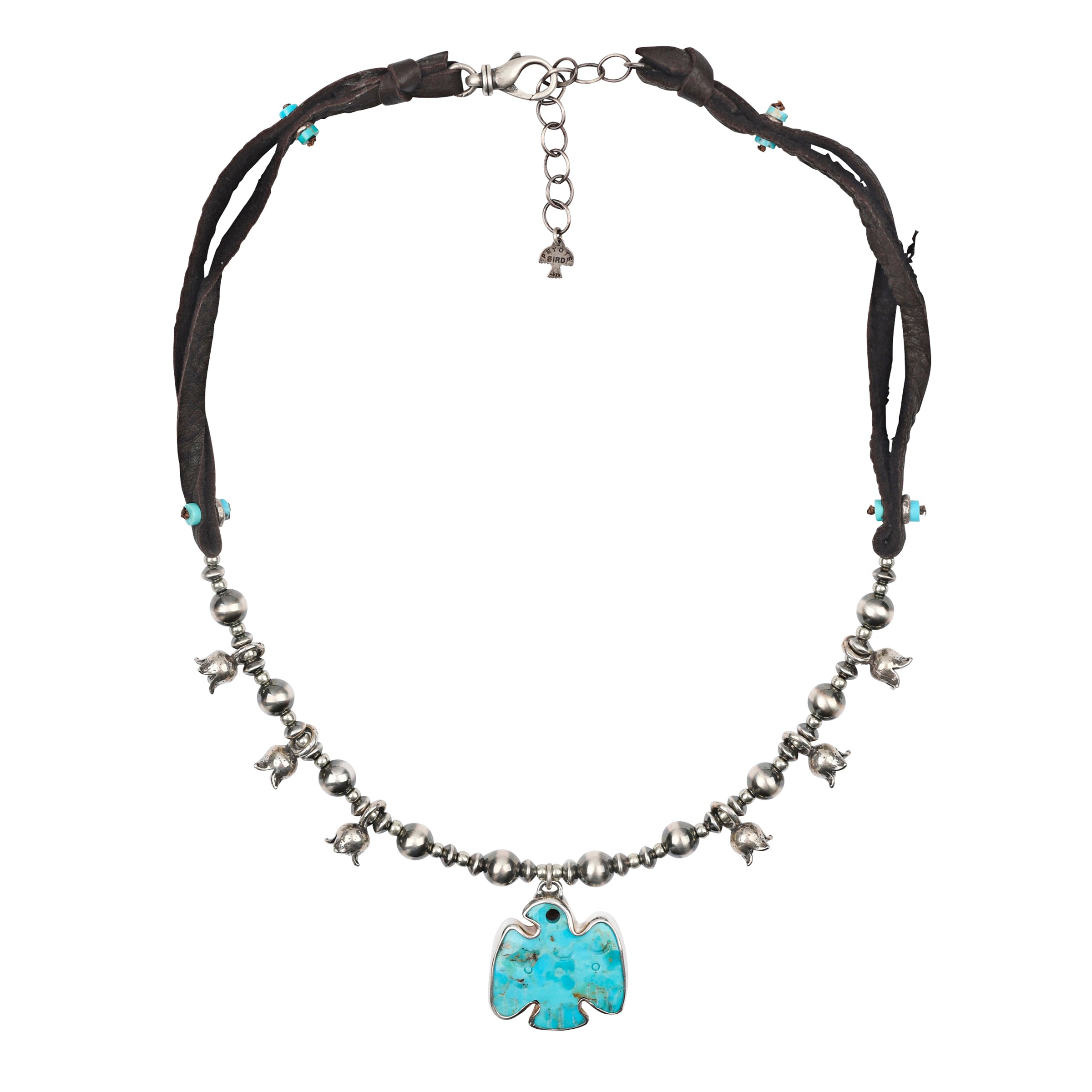 A thunderbird turquoise pendant strung on Deerskin Leather and a strand of Desert Pearls with Sterling Silver Blossom charms