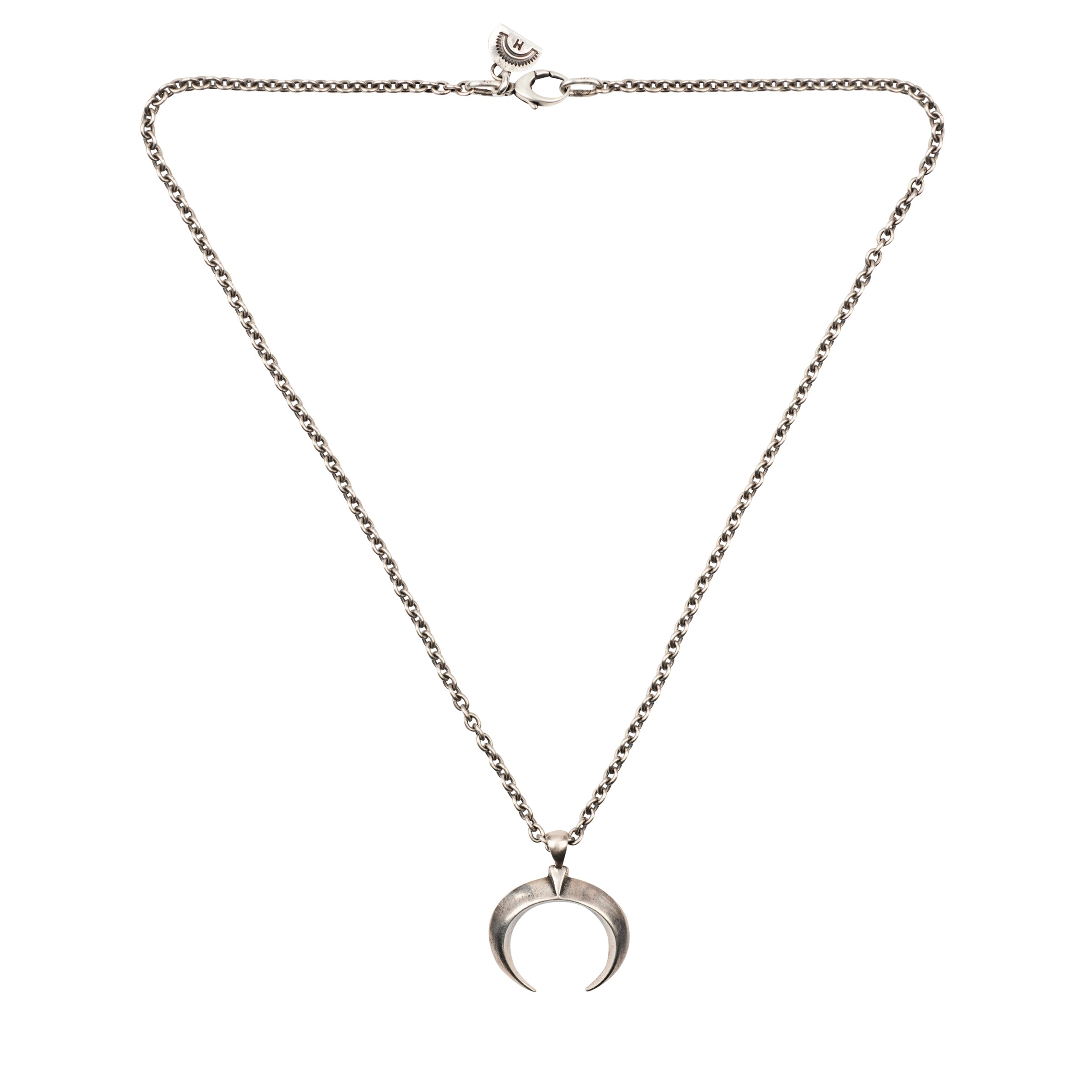 A sterling silver chain necklace with a naja pendant from New Mexico artist Dennis Hogan.