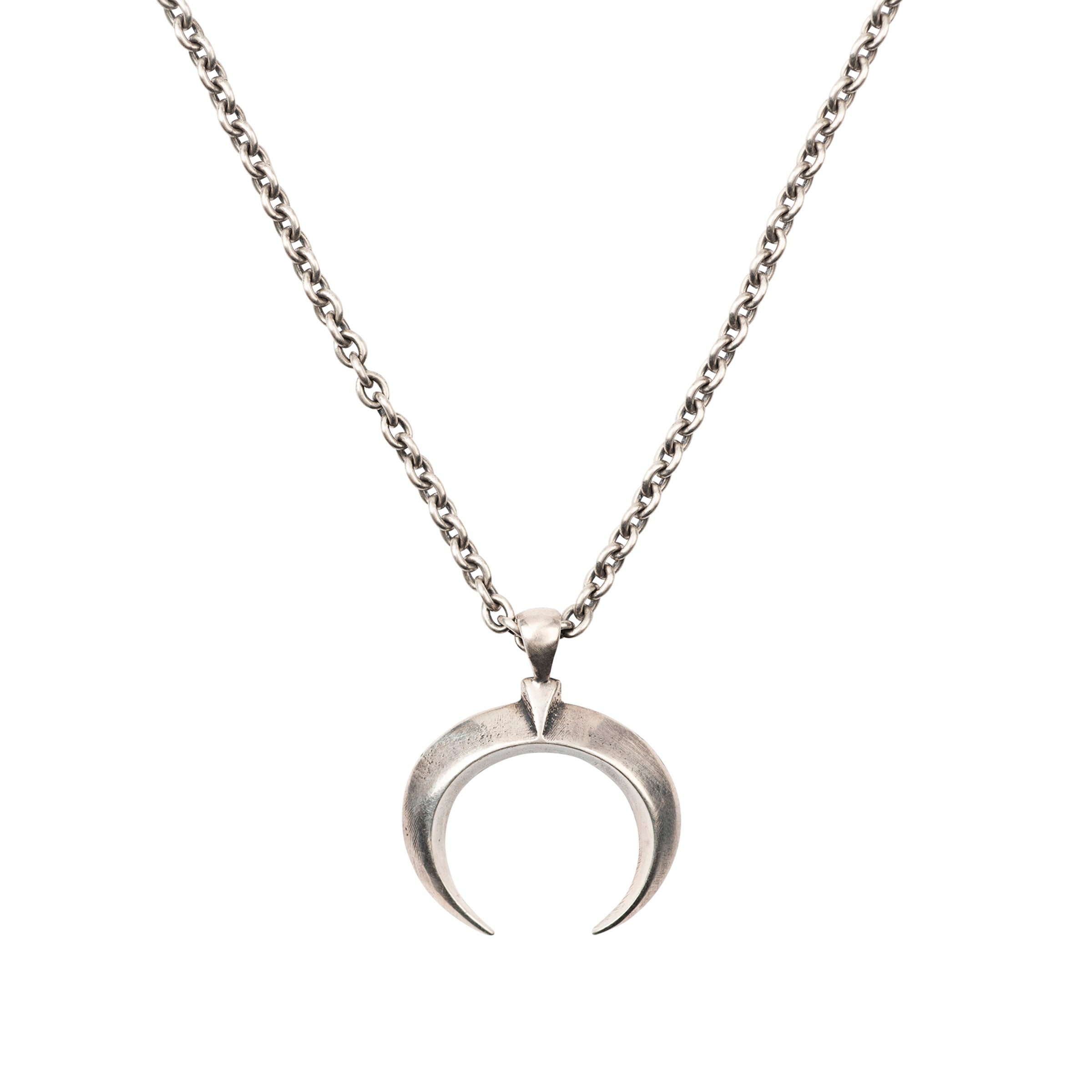 A sterling silver chain necklace with a naja pendant from New Mexico artist Dennis Hogan.