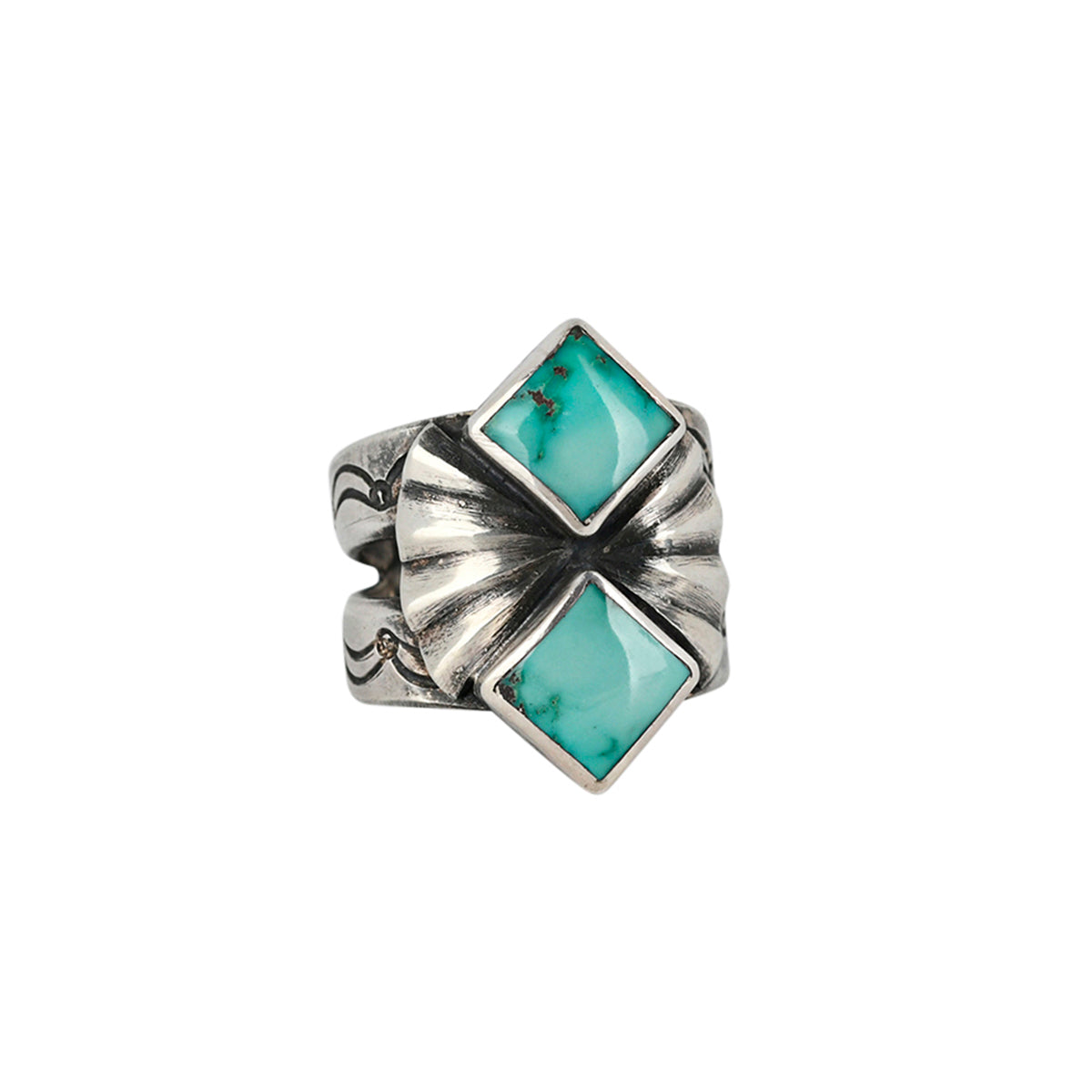 A southwestern sterling silver ring featuring two diamond shape turquoise stones surrounded by santa fe style motifs