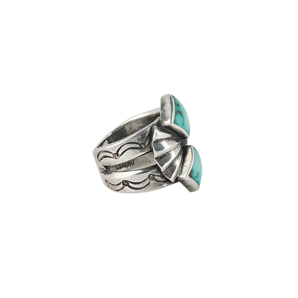 A southwestern sterling silver ring featuring two diamond shape turquoise stones surrounded by santa fe style motifs