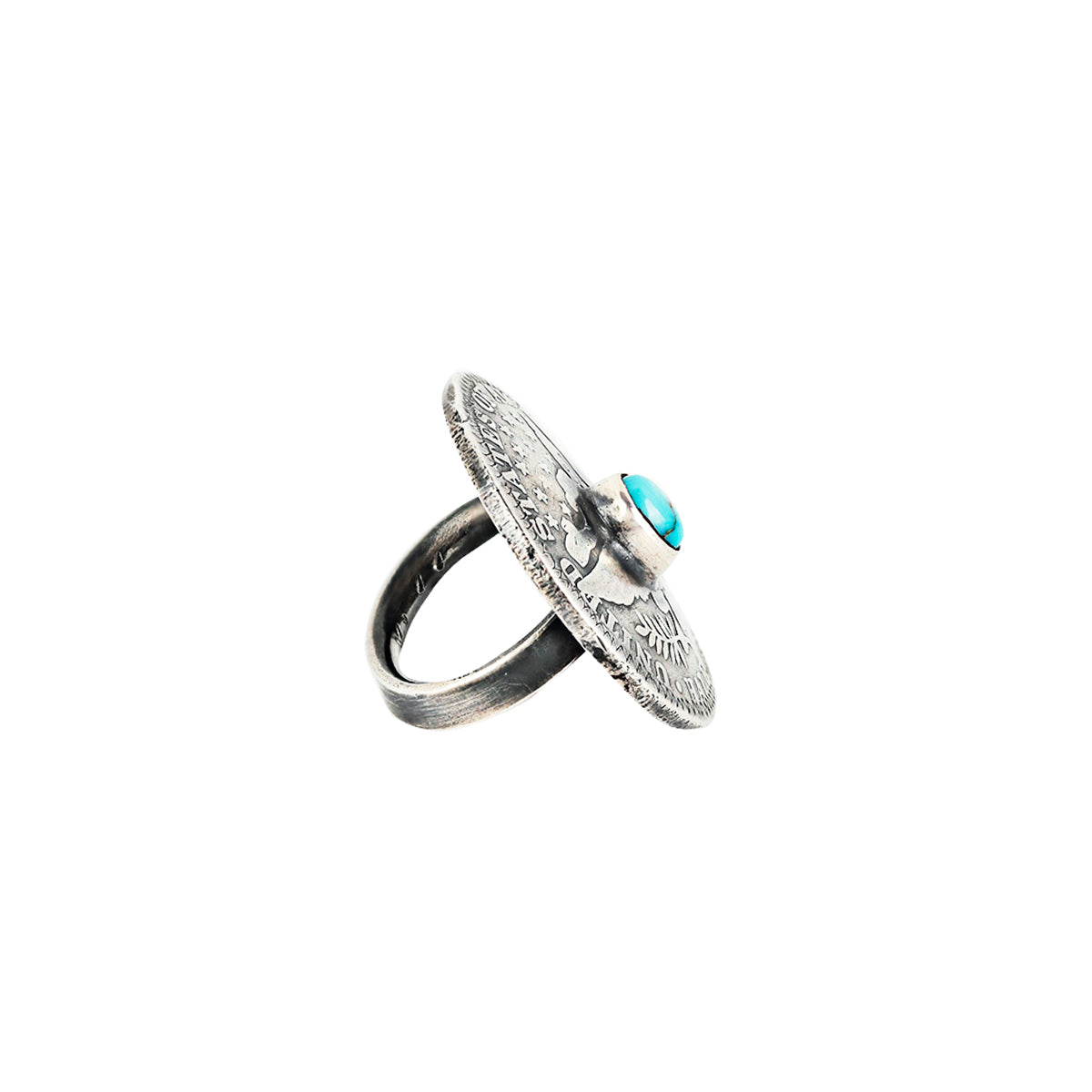 A silver coin ring featuring a blue turquoise stone as the centerpiece