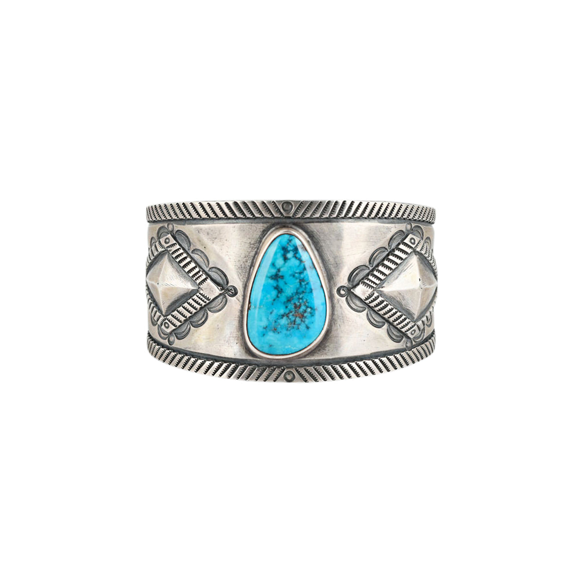A men's cuff handcrafted by Jesse Robbins from ingot coin silver and features a stunning blue turquoise stone and evokes Santa Fe style