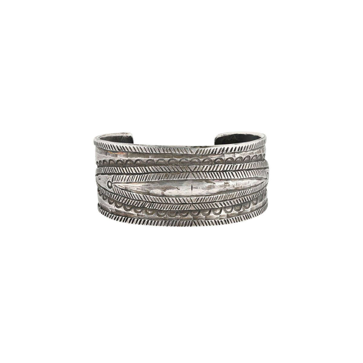 A men's cuff by Jock Favour handcrafted from ingot coin silver and stamped with Southwestern motifs