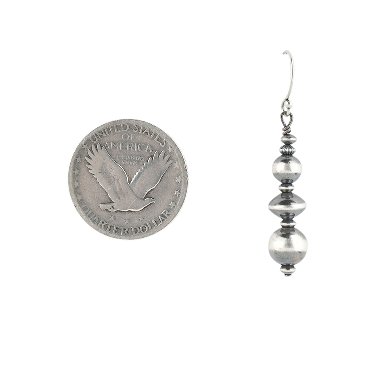 Stacked Sterling silver bead earring in multiple shapes and sizes next to coin for scale