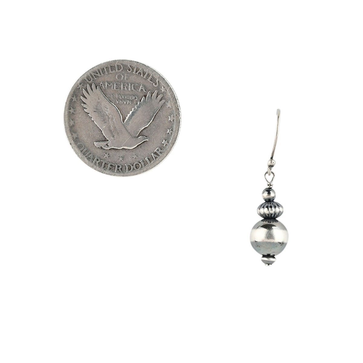 Sterling silver large beaded earring with corrugated saucer bead next to coin for scale