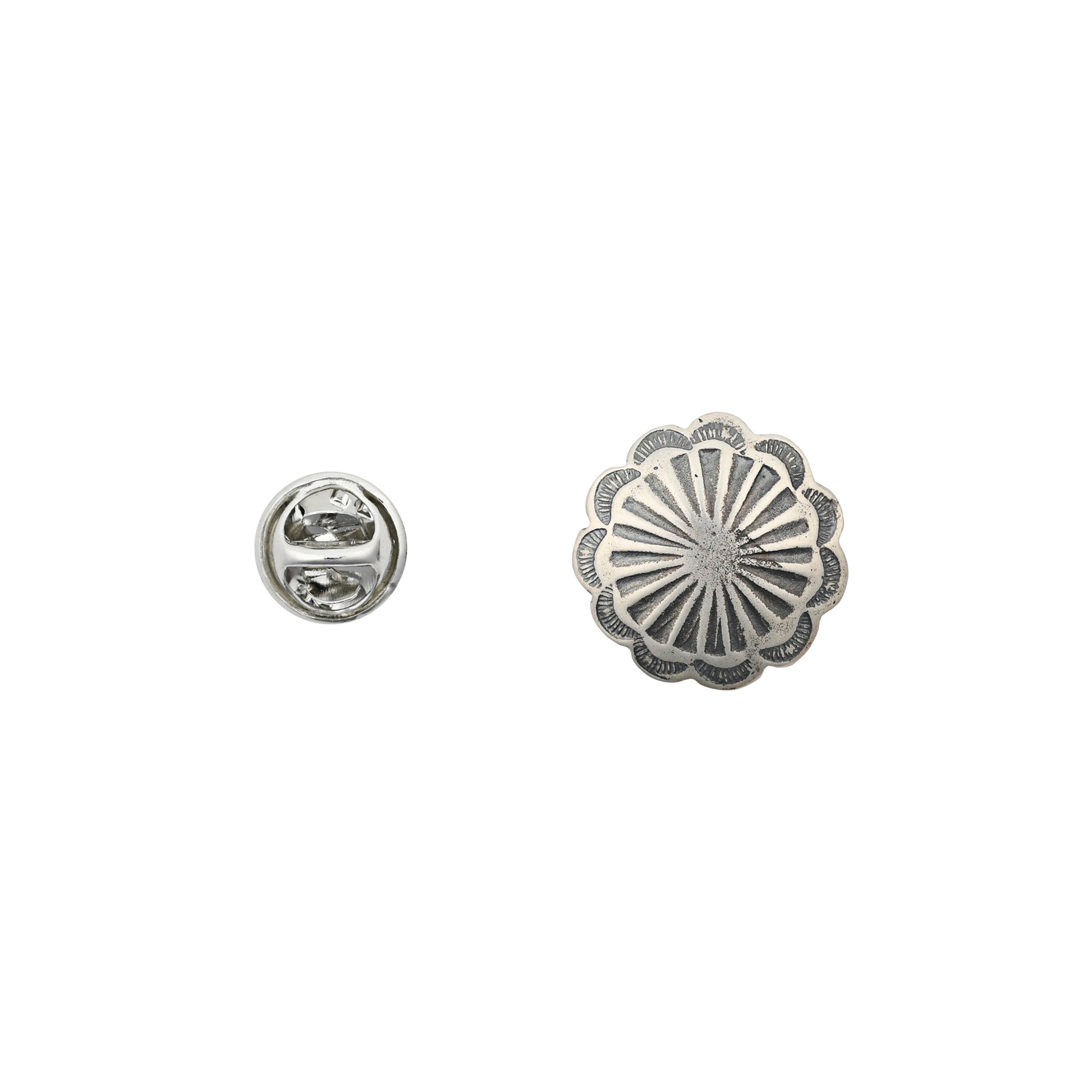 Circular shaped silver stamped pin next to pinback.