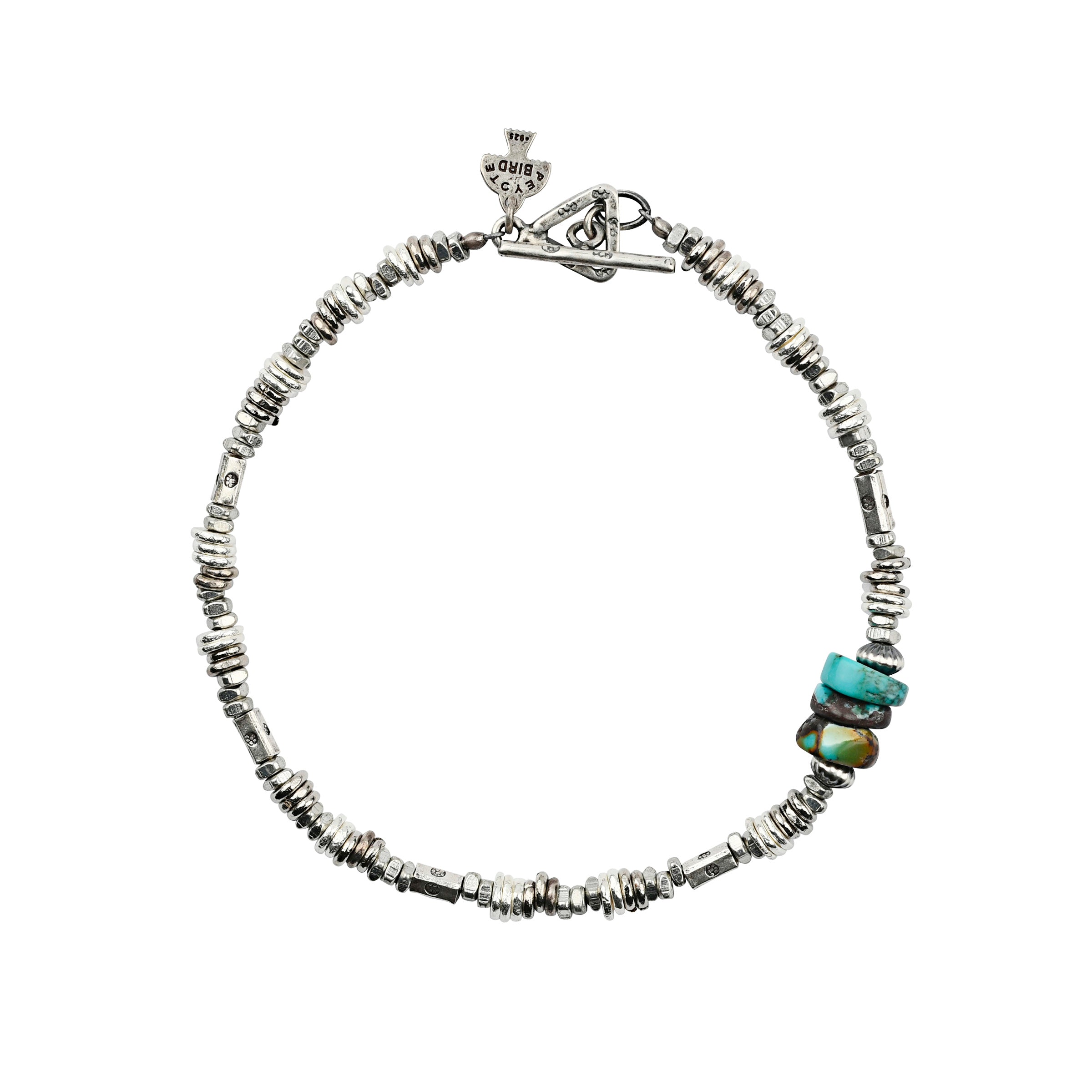 The Silver Fox Bracelet is comprised of sterling silver and turquoise beads.