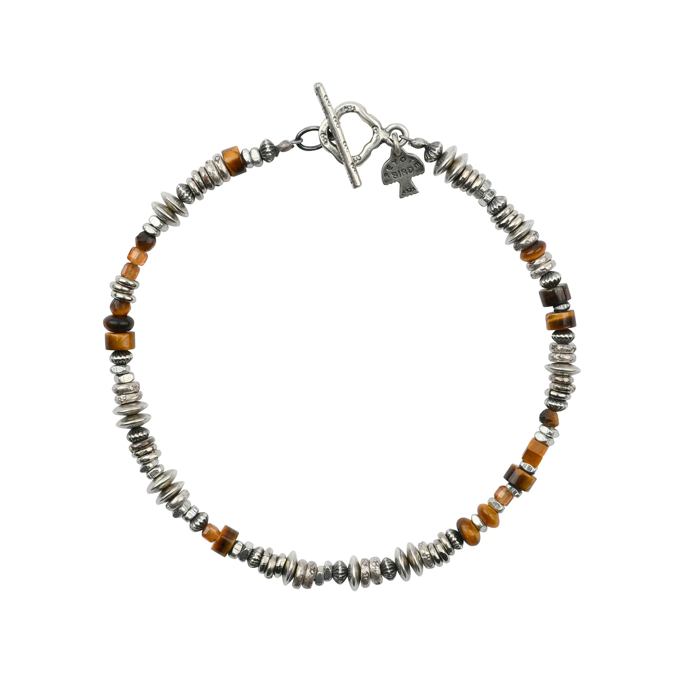 The Jemez bracelet is hand-strung with sterling silver, garnet, tigers eye and hessonite beads