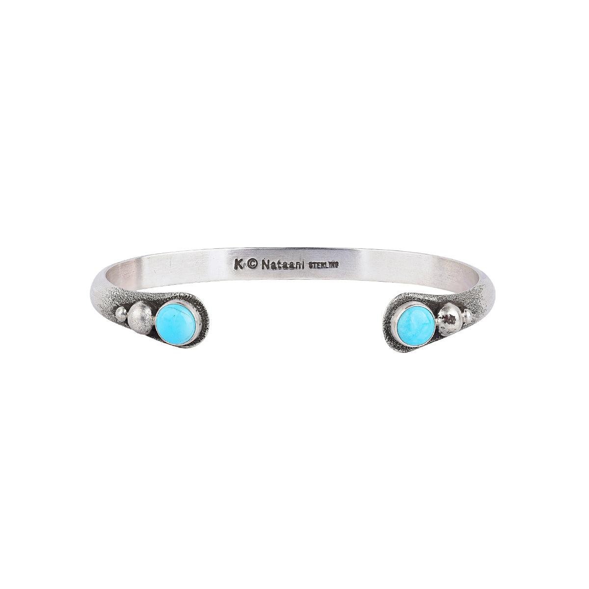 Sterling silver cuff with turquoise and silver dots on both terminals.
