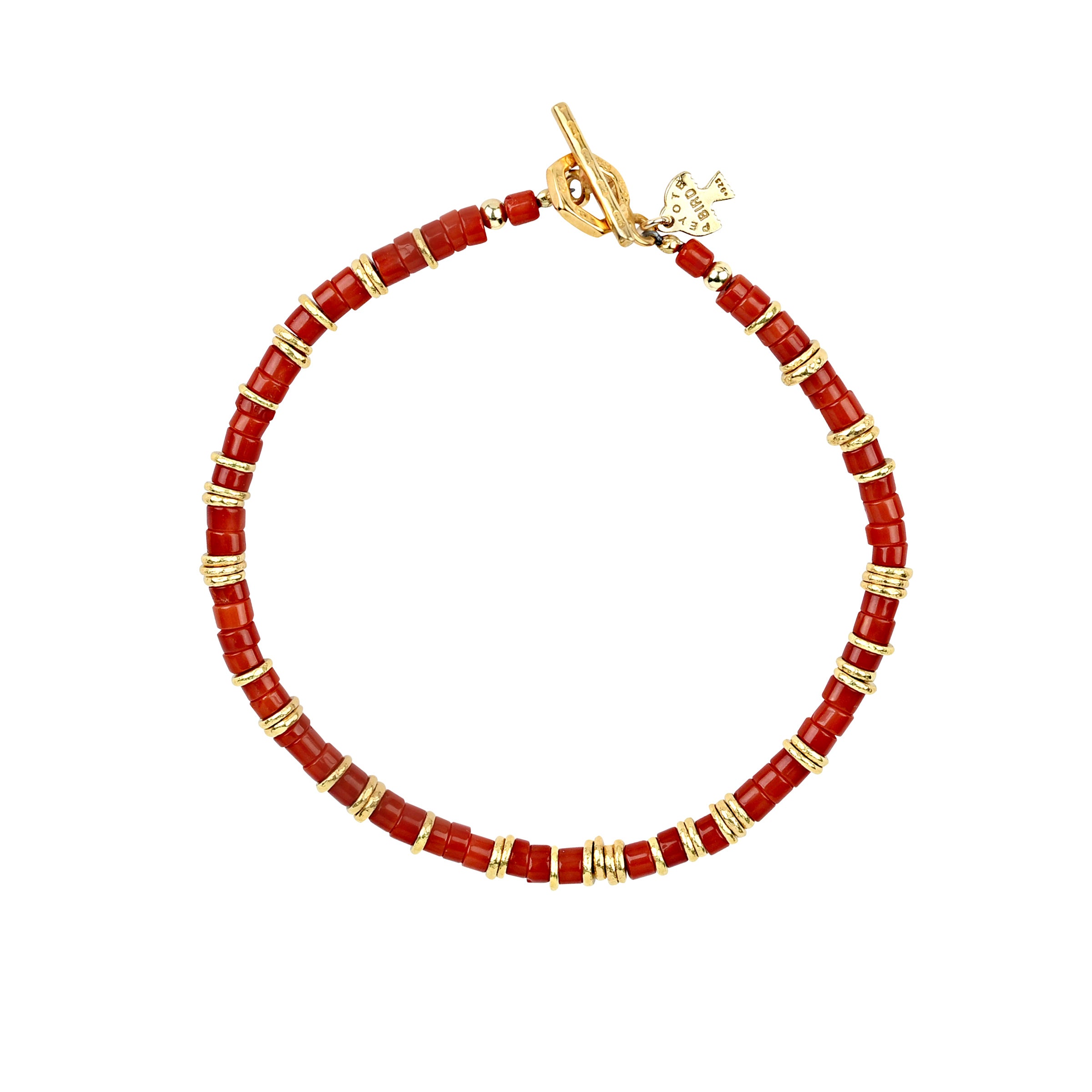 The Pilar bracelet is strung with coral heishi and 14k gold plate